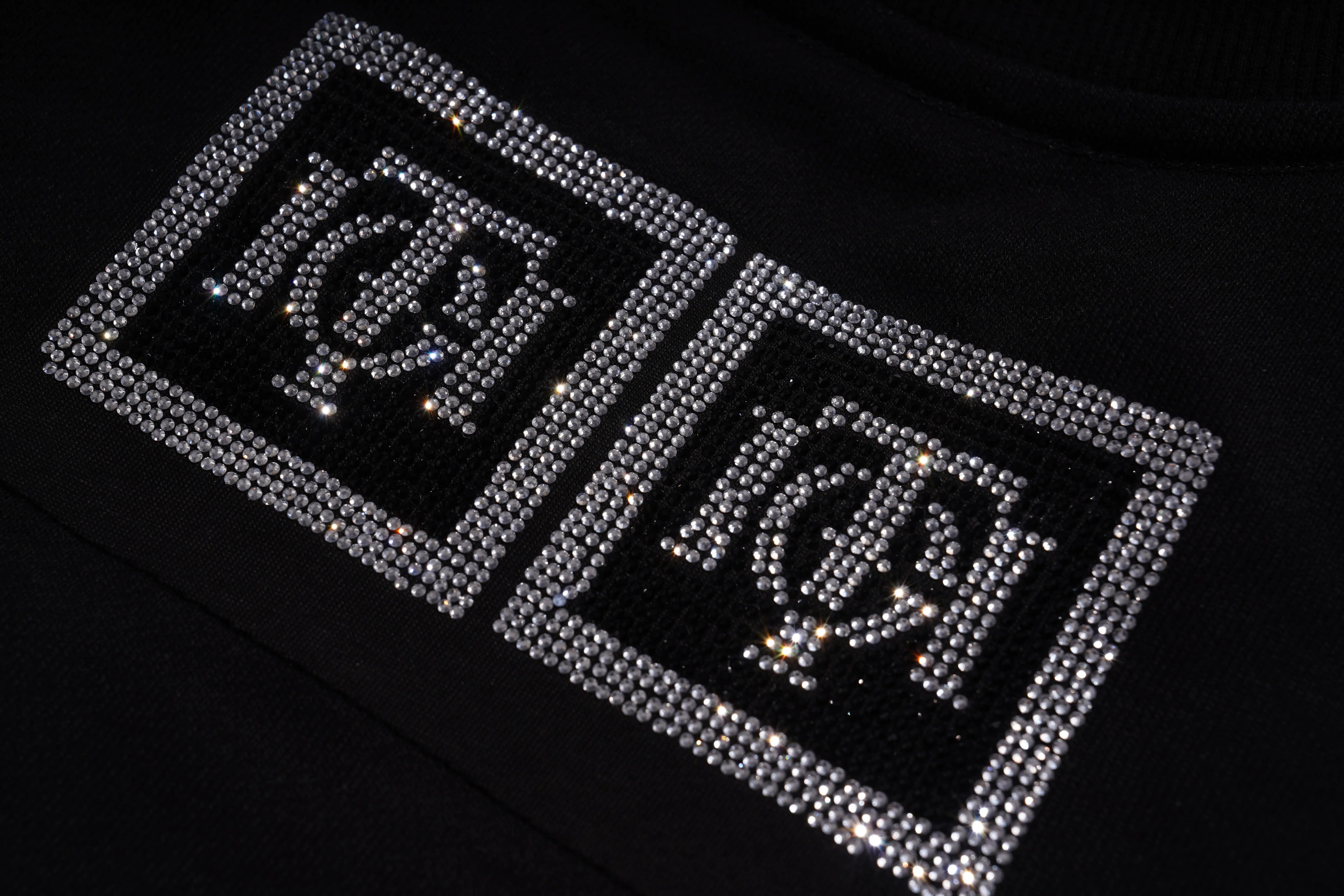 Decorative patches with symbols on a black background, TCH 1976 Rhinestone Wings Sweatshirt