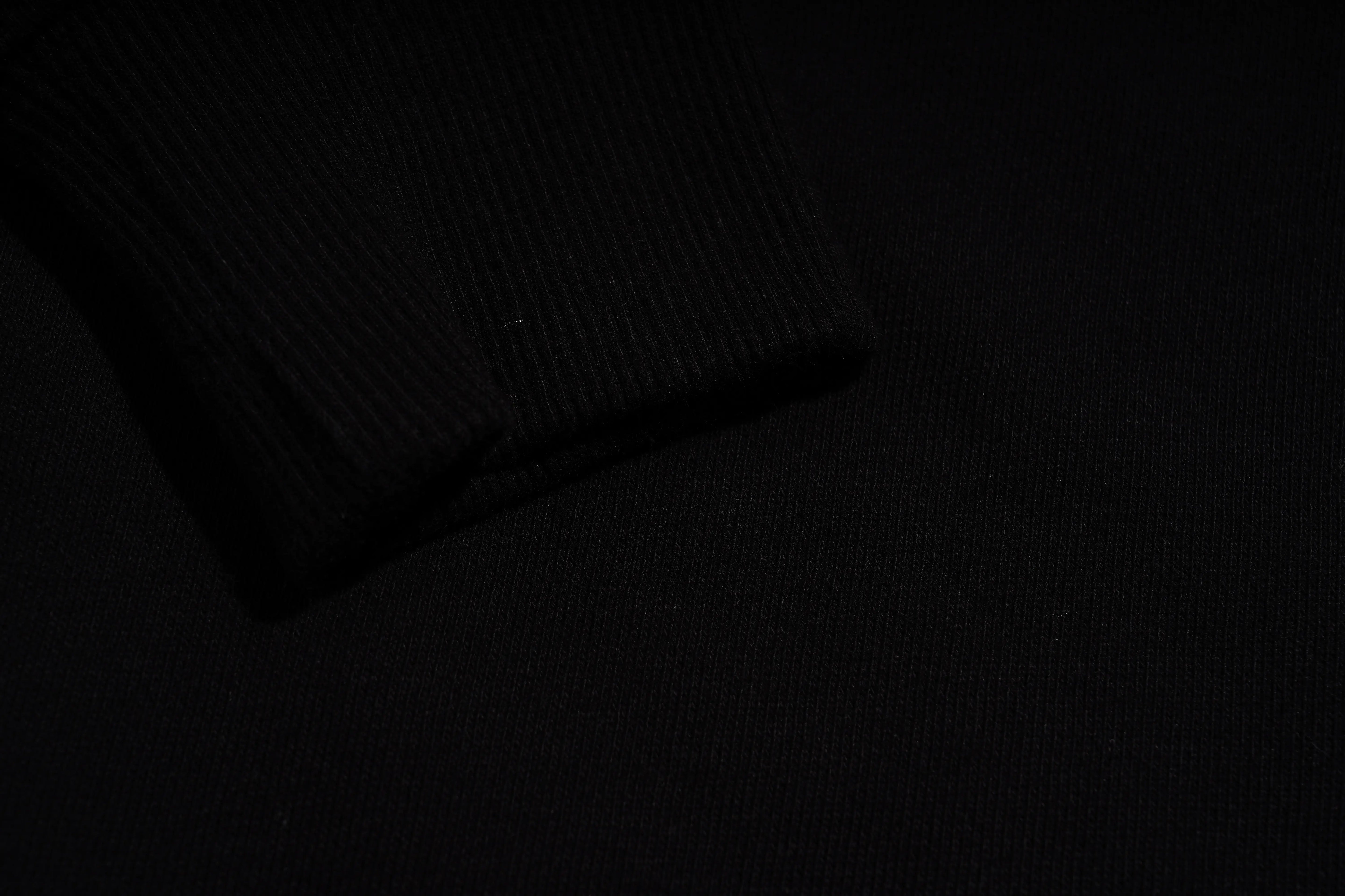 Black wallet on a dark textured surface, TCH 1976 Rhinestone Wings Sweatshirt