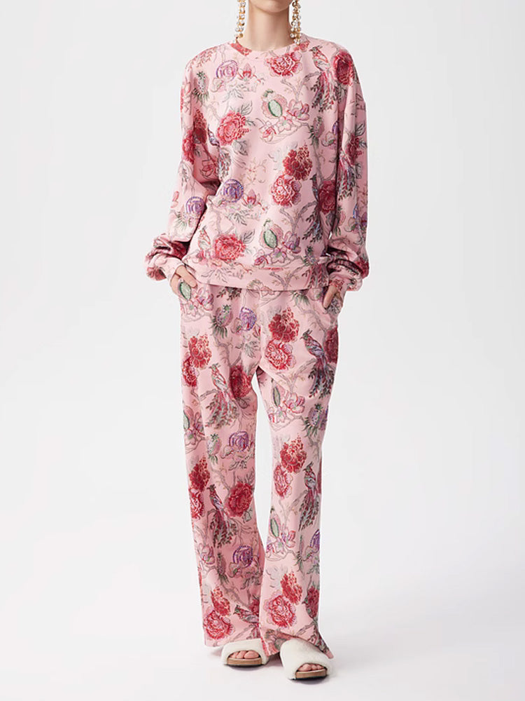 A woman wearing a pink floral print long-sleeve top and matching wide-leg long pants. TCH 2 Piece Floral Print Sparkly Top and Long Pants