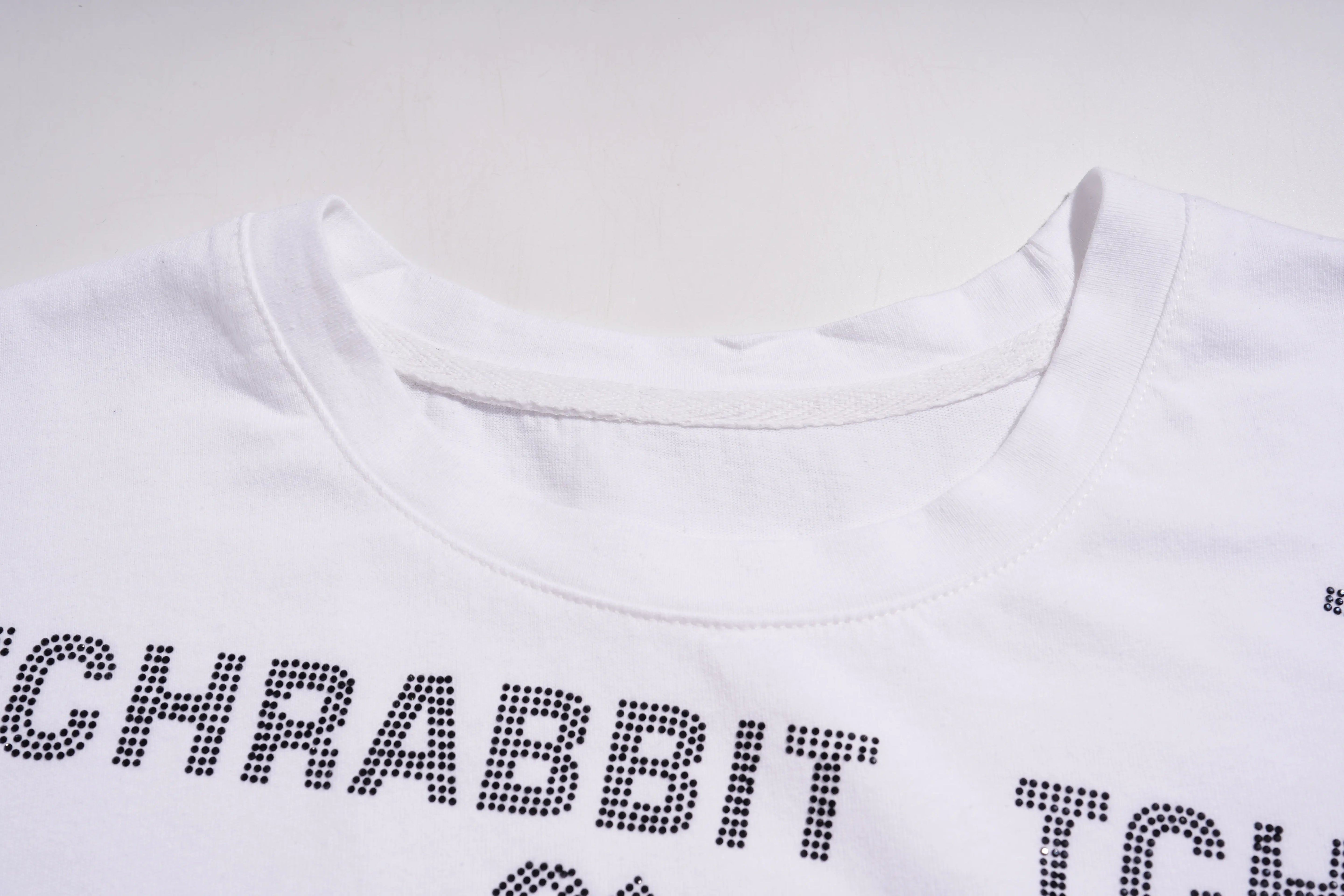 White t-shirt with black text on a light gray background, TCH All-Over TCHRABBIT Logo T-Shirt