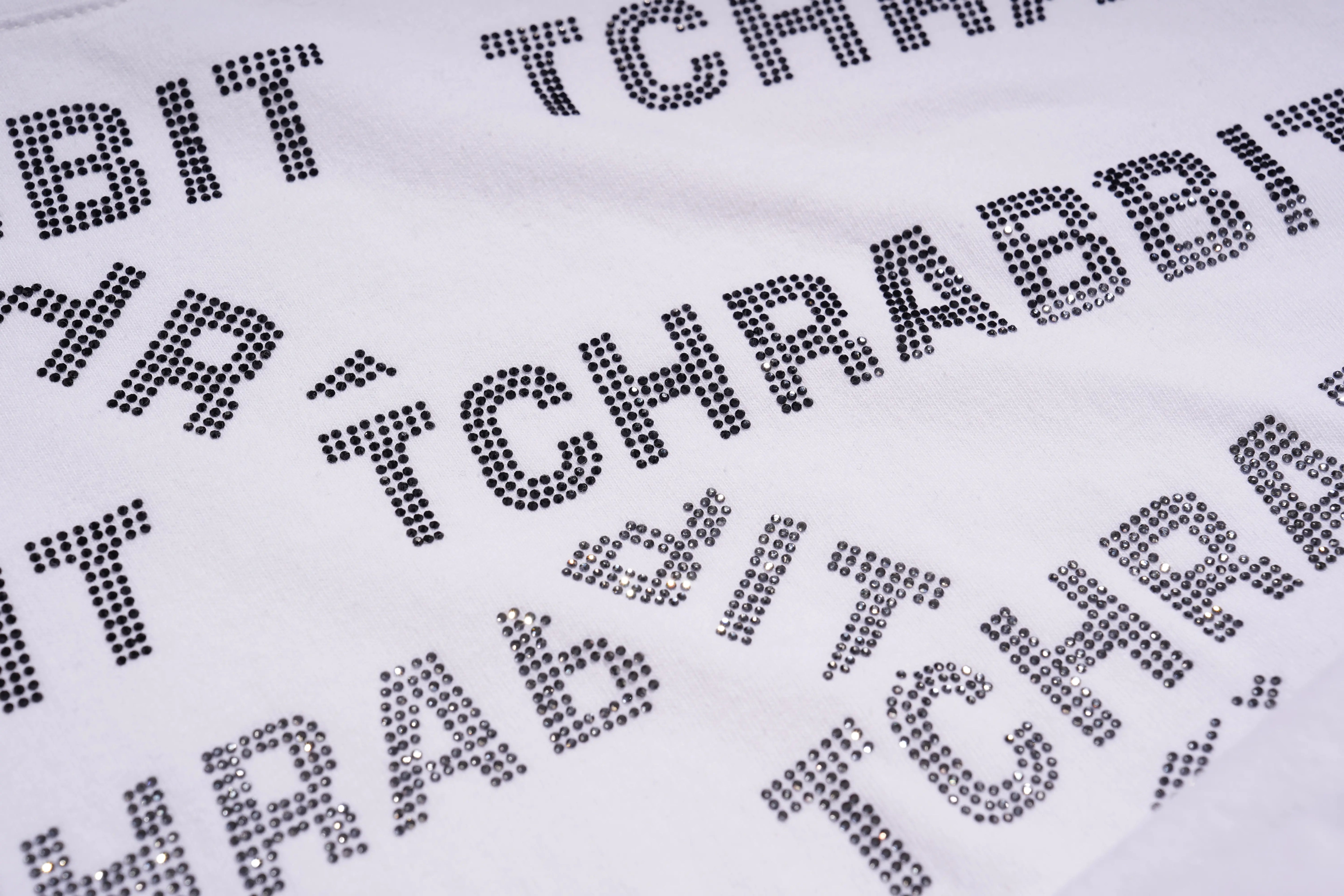 Text pattern with 'TCHRAVIT' and 'TCHRABY' on a white background, TCH All-Over TCHRABBIT Logo T-Shirt