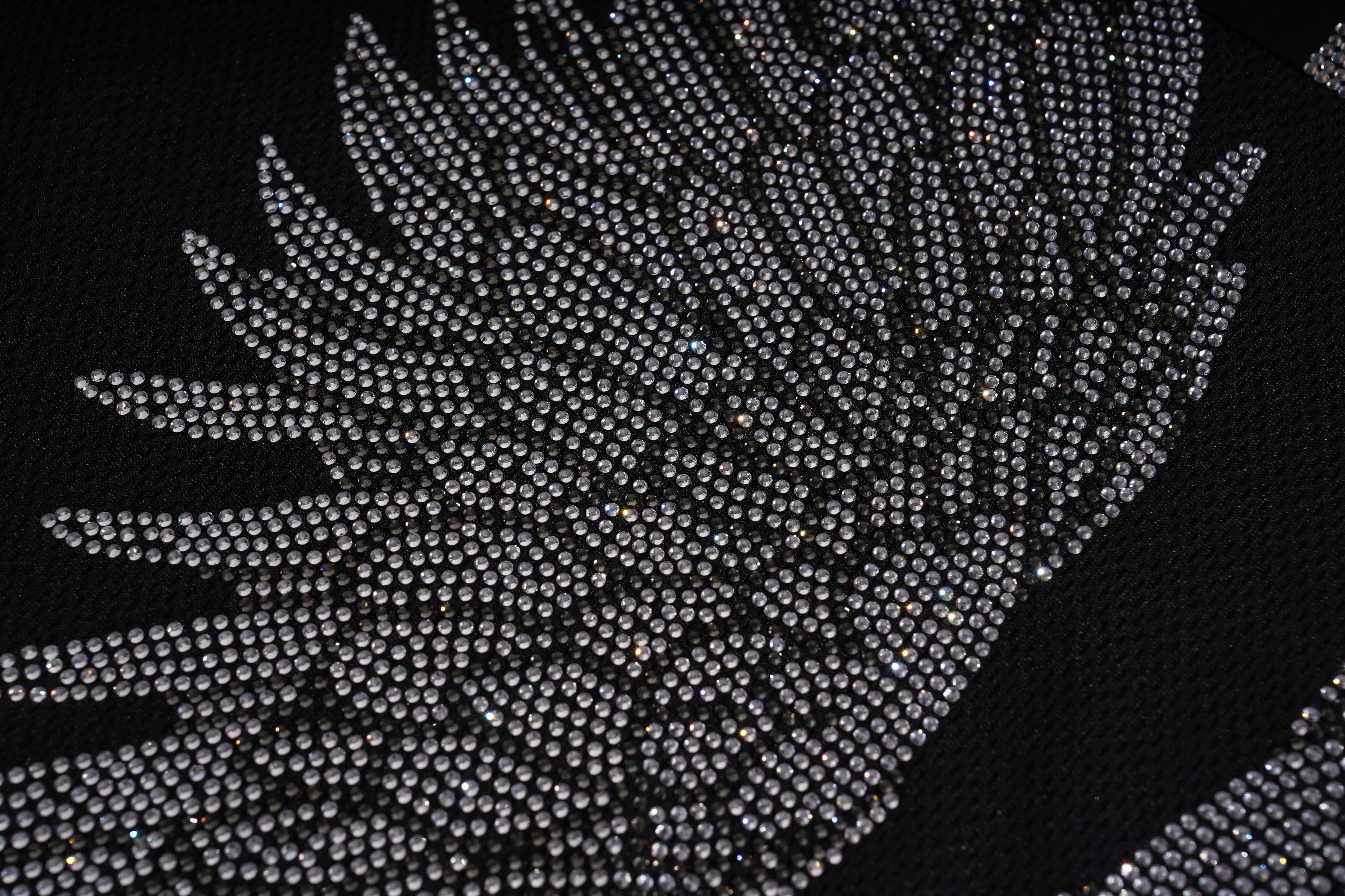 Close-up of a black fabric with silver beaded pattern, TCH Angel Wings Rhinestone V-Neck Tee