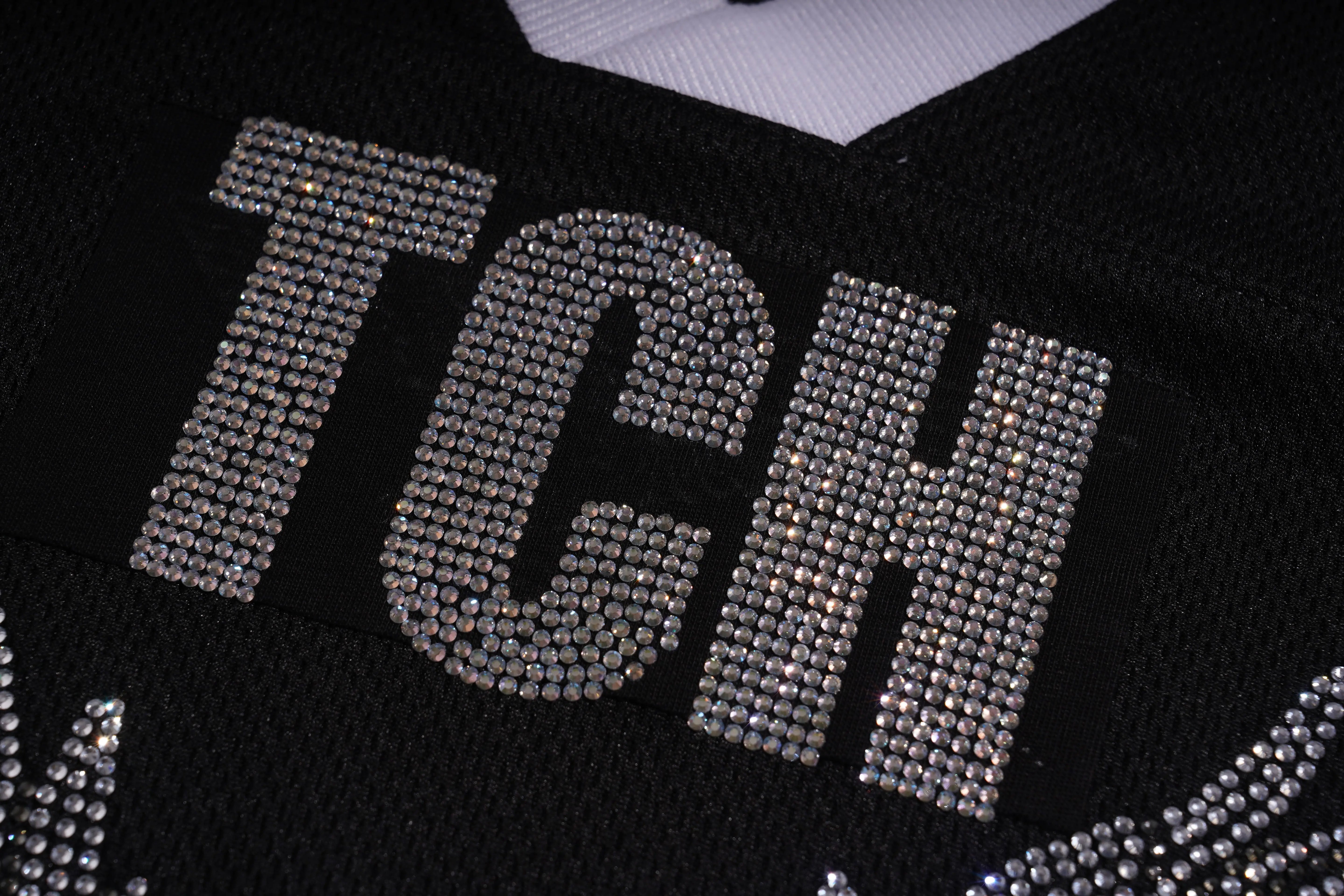 Black sweater with 'TCN' lettering made of rhinestones, TCH Angel Wings Rhinestone V-Neck Tee