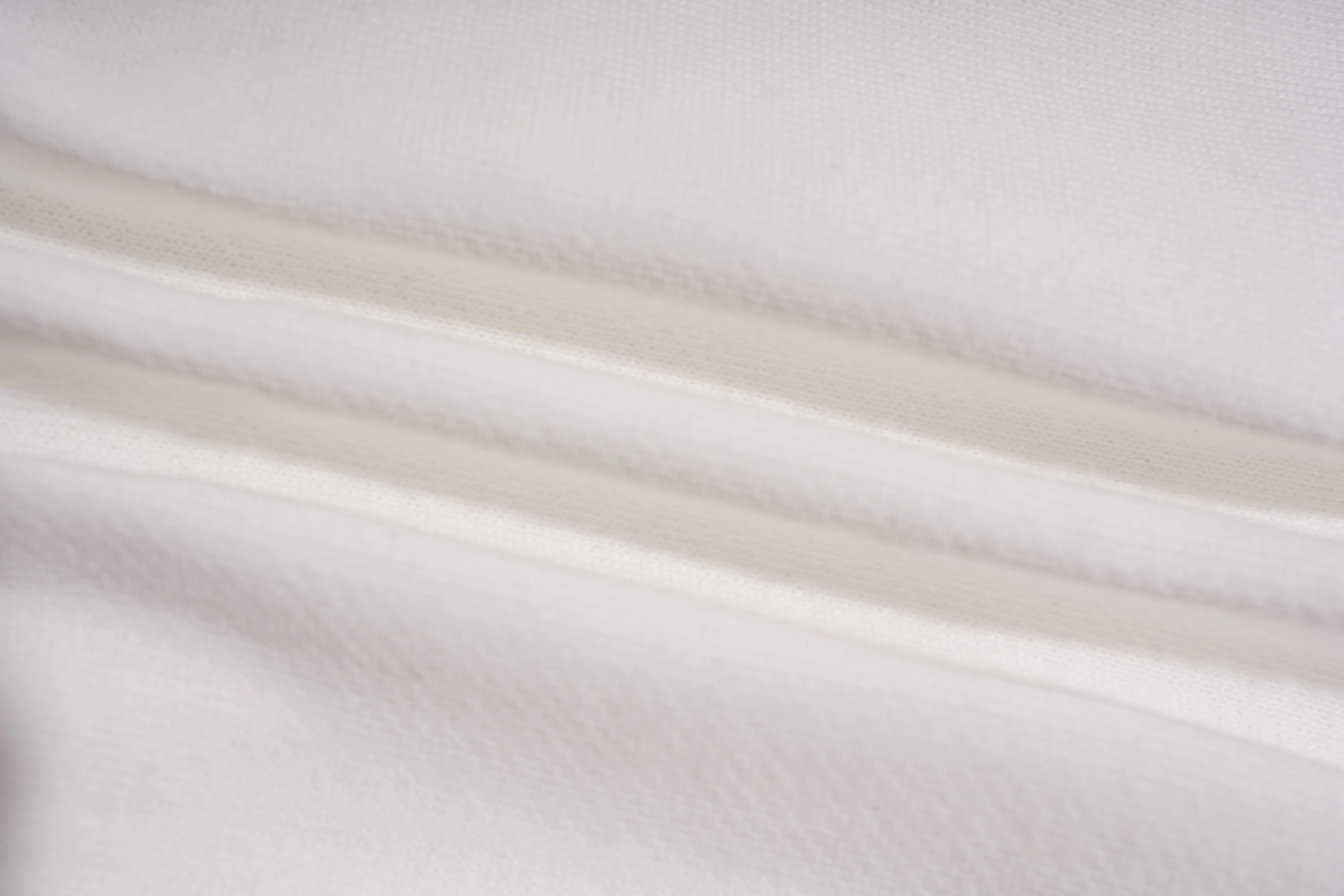 Close-up of white fabric with subtle texture