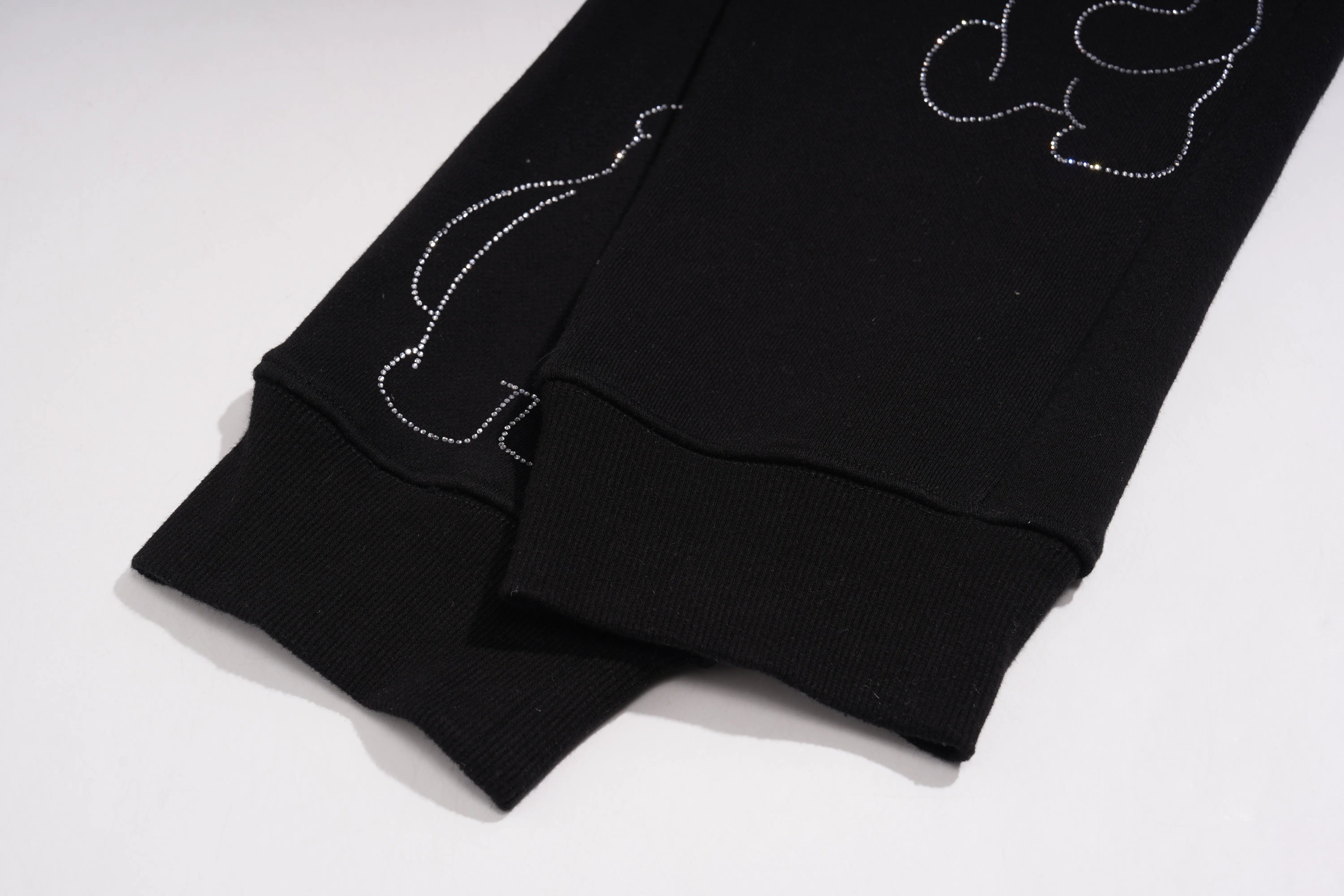 Black fabric with decorative stitching on a white background, TCH Bear Sketch Rhinestone Jogger Pants