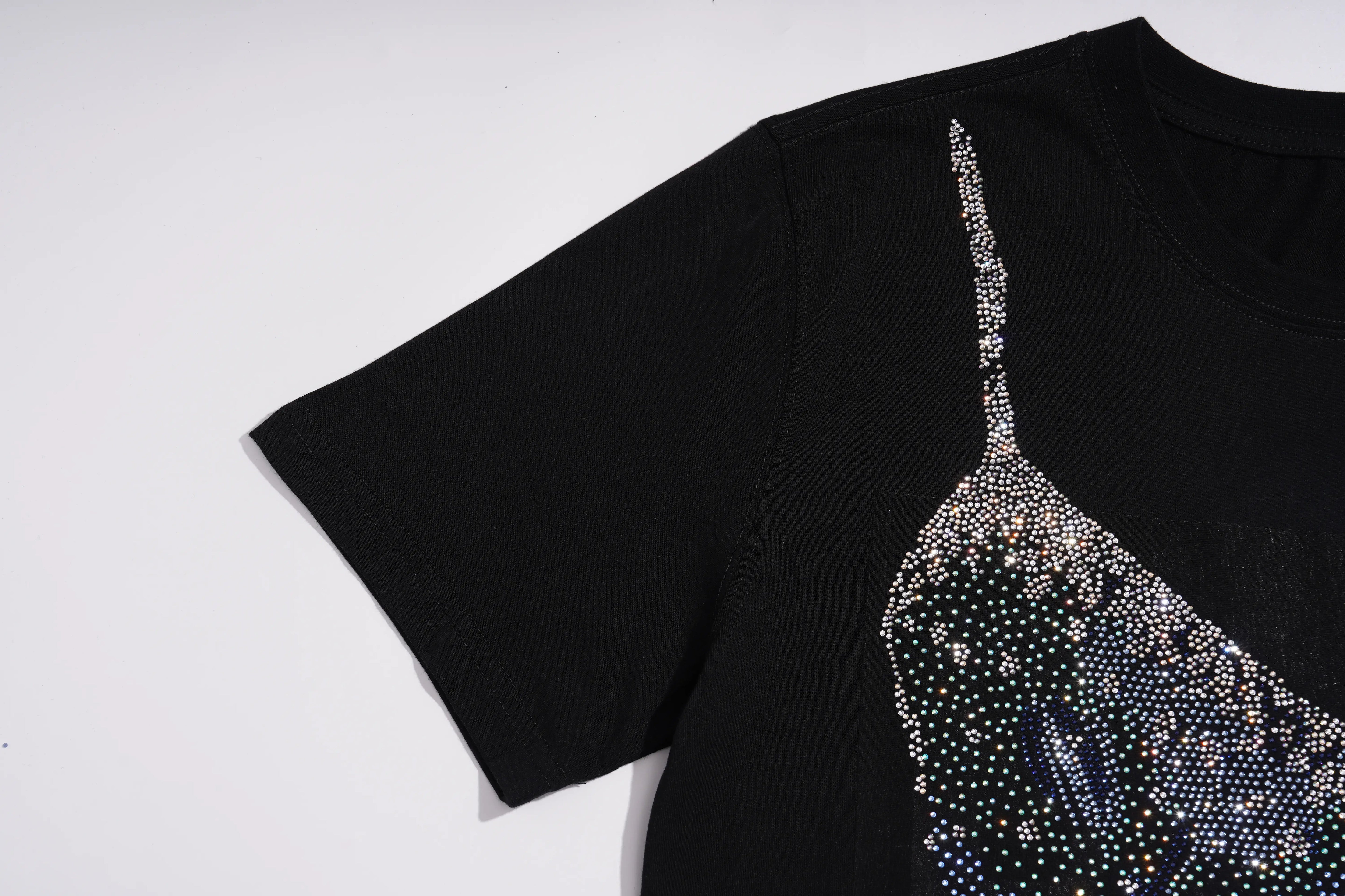 A black short-sleeve t-shirt featuring a sheer, spaghetti-strap style graphic overlay embellished with shimmering silver rhinestones, laid flat against a white background. TCH Black Rhinestone Corset Graphic T-Shirt