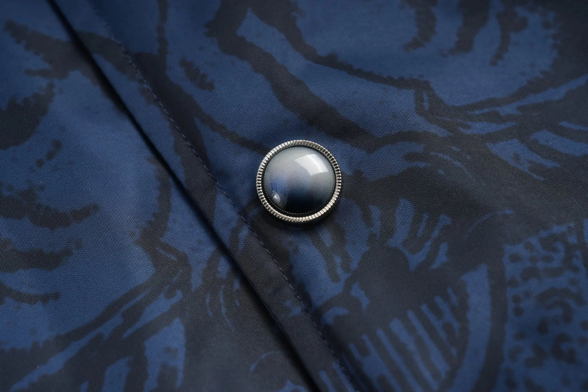 TCH Blue Baroque Pattern Embroidered Varsity Jacket TCH blue varsity jacket Blue baroque pattern jacket Gothic graphic varsity jacket Navy blue streetwear jacket Baroque print bomber jacket Embroidered varsity jacket Gothic lettering jacket Blue snap-button jacket Ornamental print streetwear jacket TCH graphic bomber jacket
