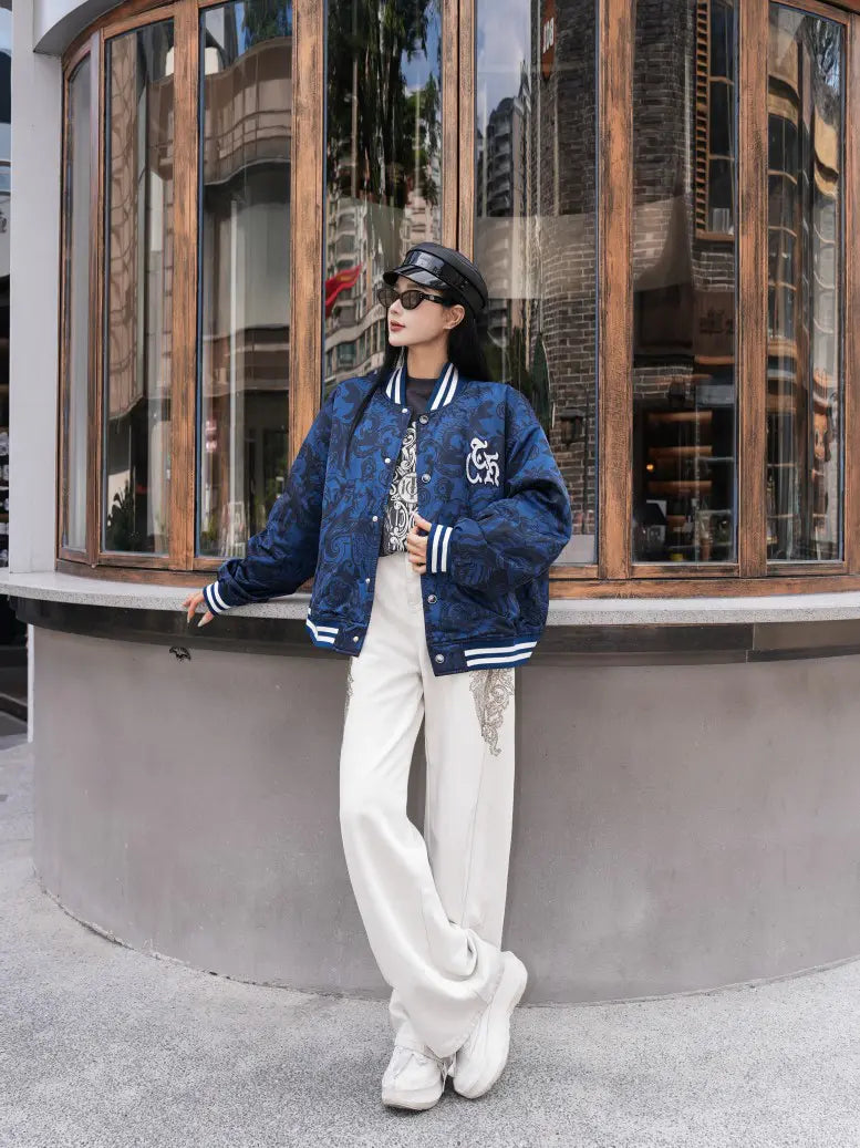 TCH Blue Baroque Pattern Embroidered Varsity Jacket TCH blue varsity jacket Blue baroque pattern jacket Gothic graphic varsity jacket Navy blue streetwear jacket Baroque print bomber jacket Embroidered varsity jacket Gothic lettering jacket Blue snap-button jacket Ornamental print streetwear jacket TCH graphic bomber jacket