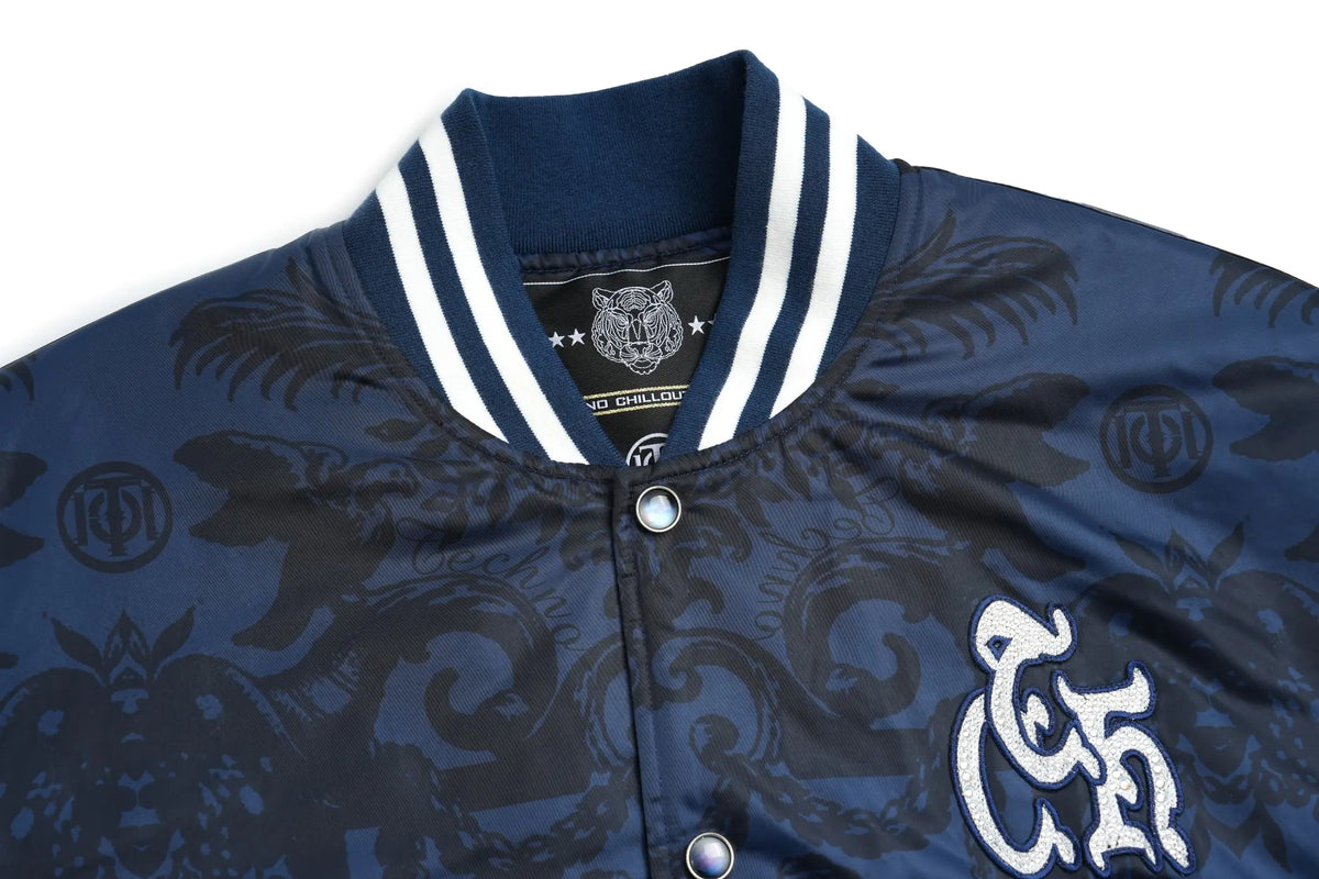 TCH Blue Baroque Pattern Embroidered Varsity Jacket TCH blue varsity jacket Blue baroque pattern jacket Gothic graphic varsity jacket Navy blue streetwear jacket Baroque print bomber jacket Embroidered varsity jacket Gothic lettering jacket Blue snap-button jacket Ornamental print streetwear jacket TCH graphic bomber jacket