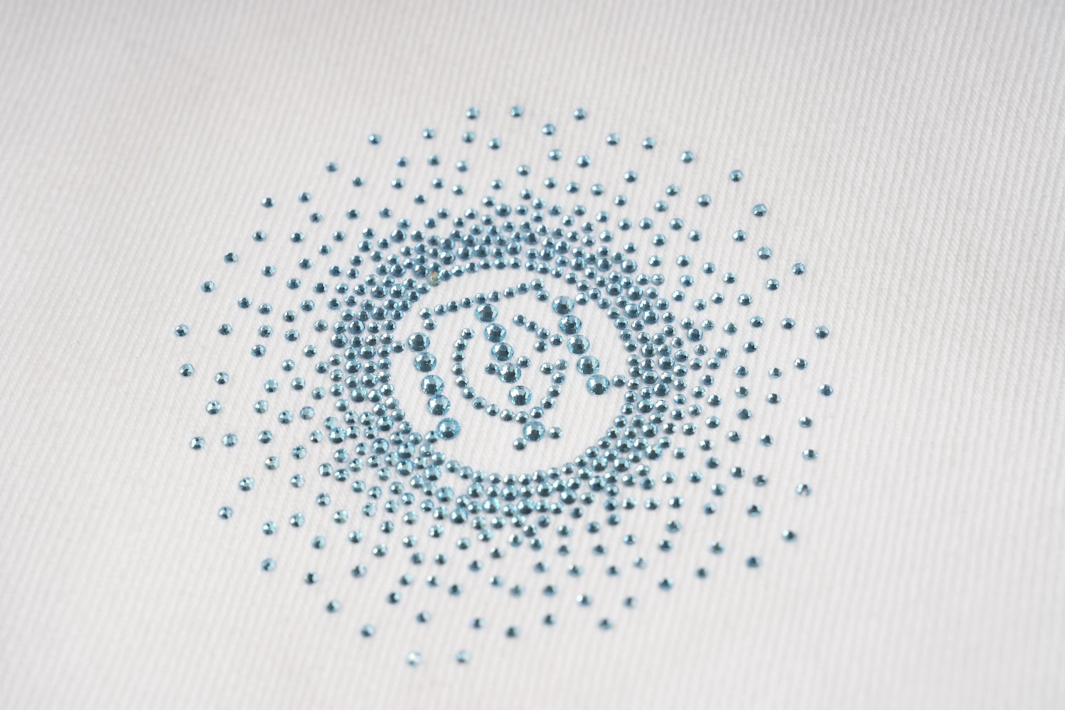 Circular pattern of blue dots on a white background, TCH Blue Rhinestone Logo & “TchmucH” White Denim Jeans
