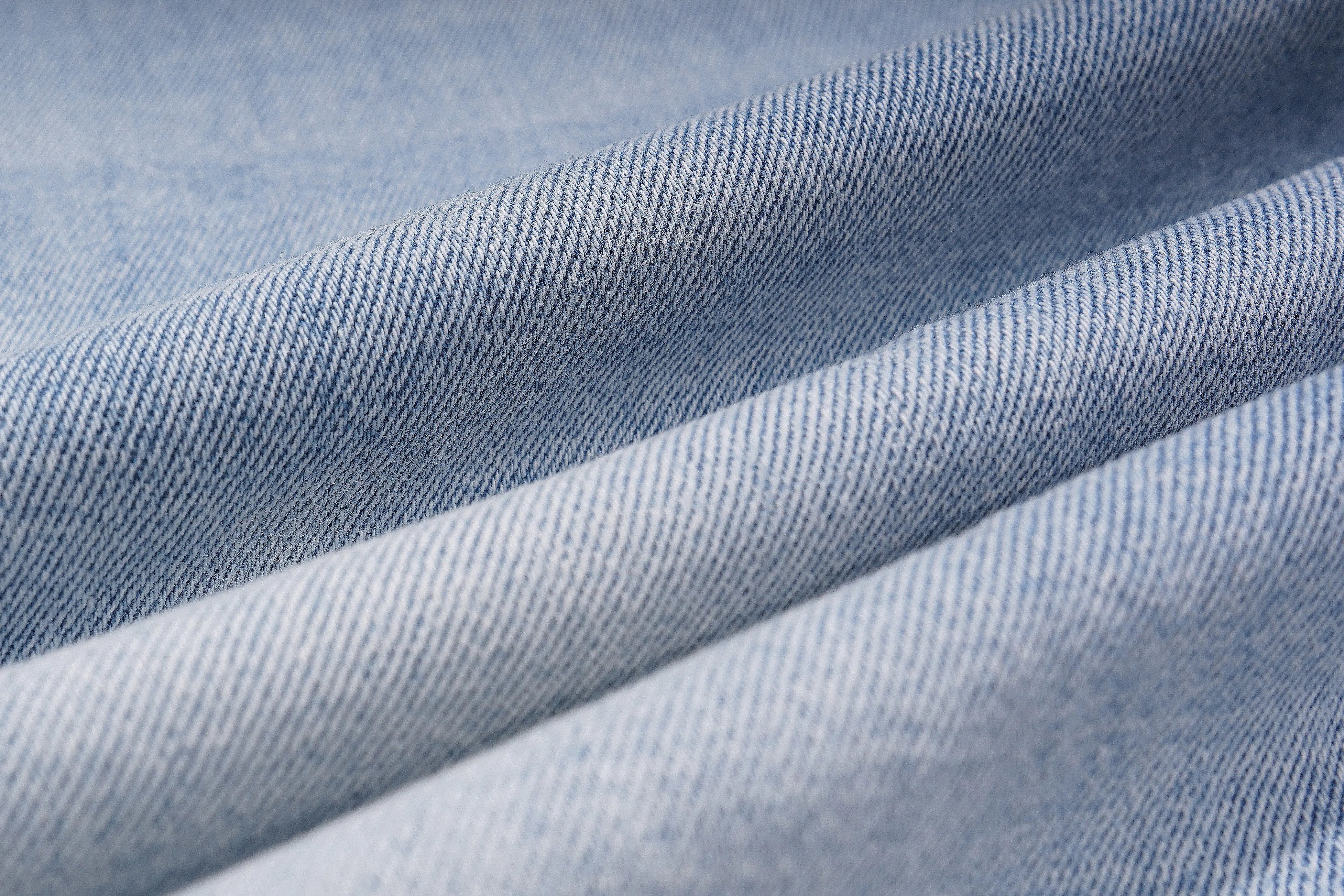 Close-up of blue denim fabric with folds, TCH Blue Snowflake Rhinestone Denim Jeans