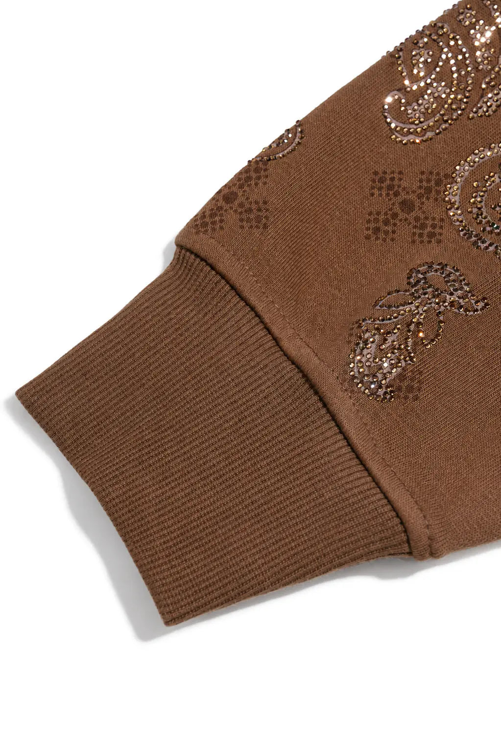 Close-up of a brown ribbed knit sleeve with sequined paisley and geometric patterns on a white background. TCH Brown Rhinestone Paisley Zip Up Hoodie