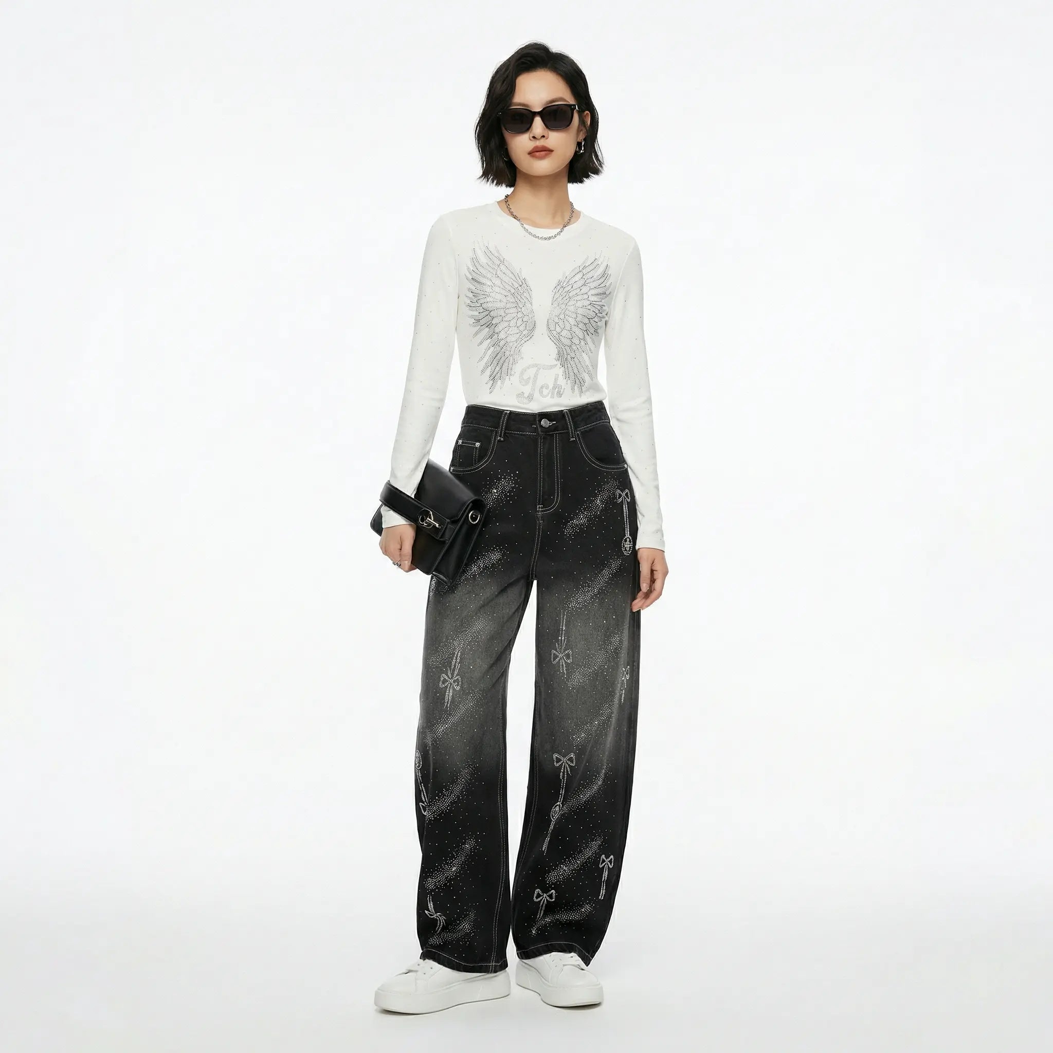 Woman wearing a white top with black embellishments and black jeans on a white background, TCH Celestial Rhinestone Wide-Leg Black Jeans