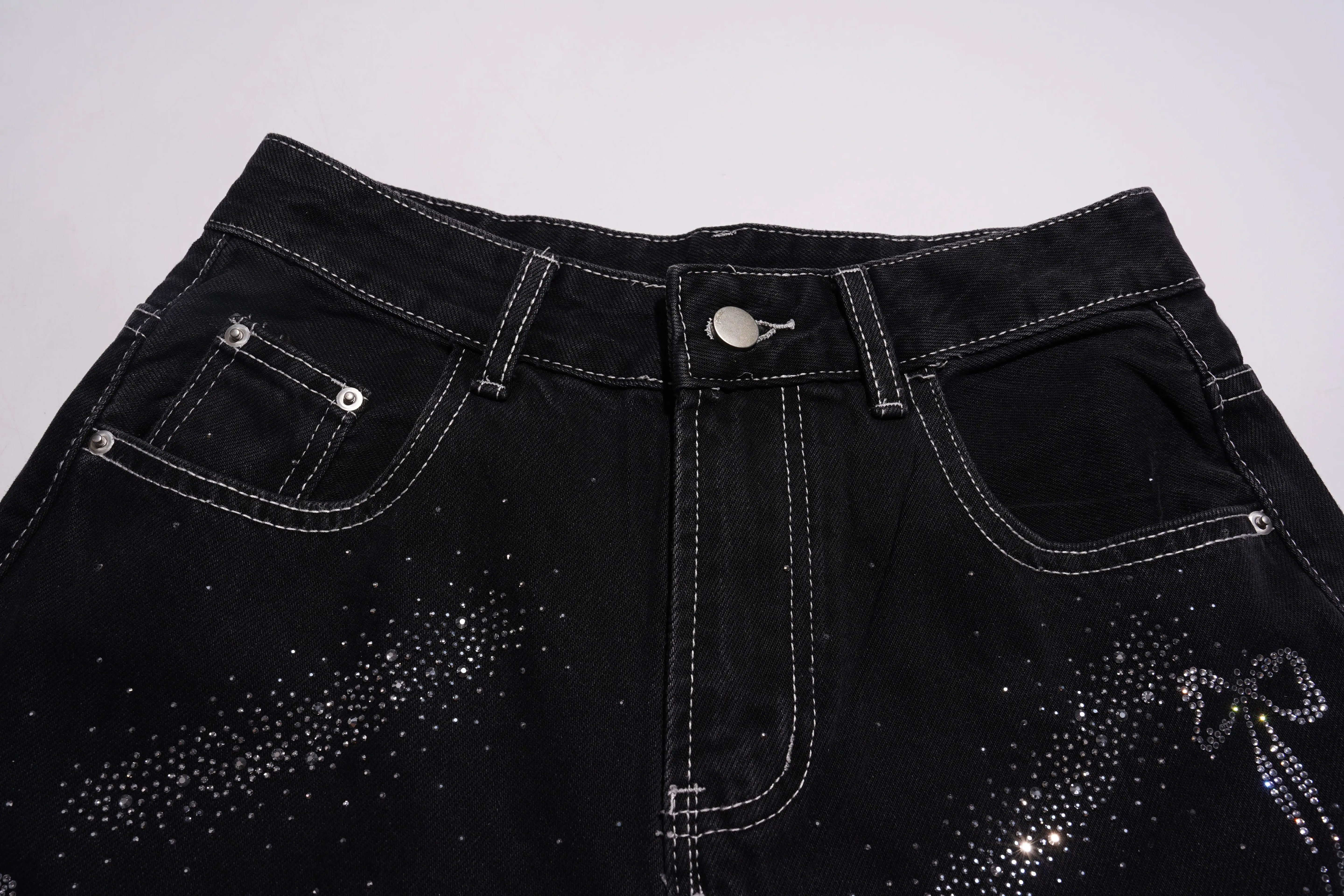 Black denim shorts with rhinestone embellishments on a white background, TCH Celestial Rhinestone Wide-Leg Black Jeans
