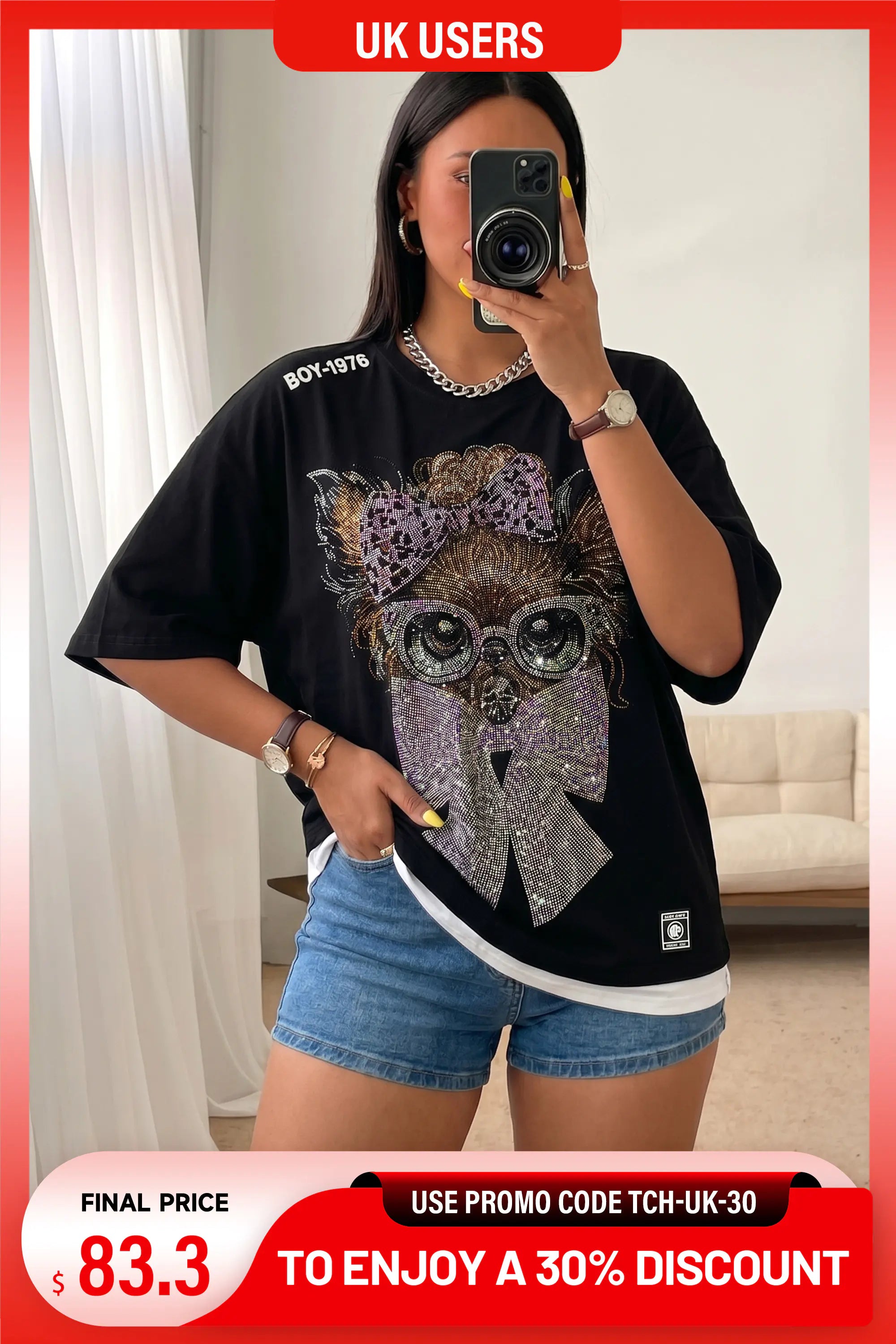 A woman takes a mirror selfie wearing a black oversized graphic T-shirt with a large glittery cat face design on the front, paired with denim shorts. The image has promotional overlays including a red banner at the top reading 'UK USERS' and a price badge at the bottom. TCH Chihuahua Bow Rhinestone T-Shirt