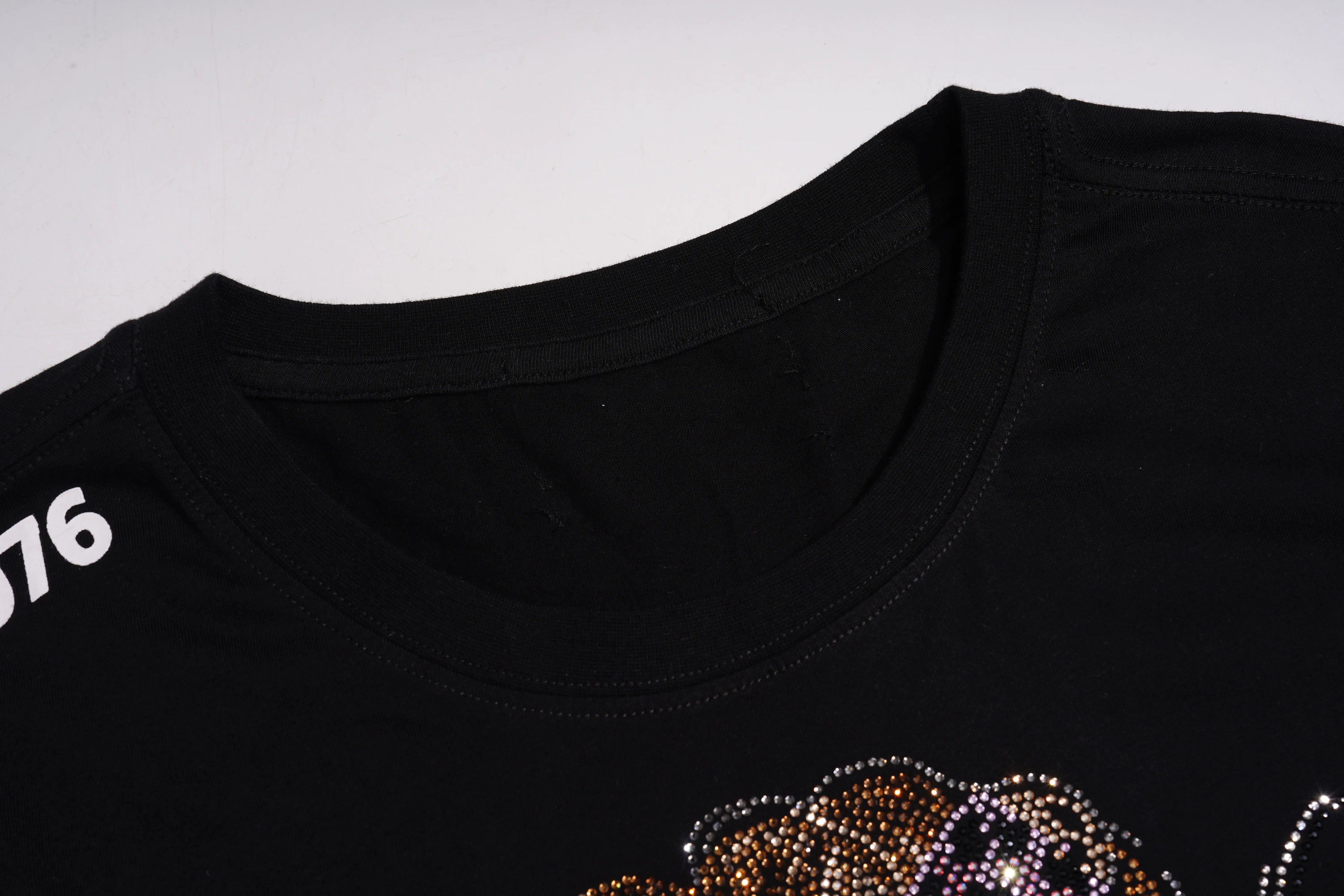 Black t-shirt with a decorative design and number 76 on a light gray background, TCH Chihuahua Bow Rhinestone T-Shirt