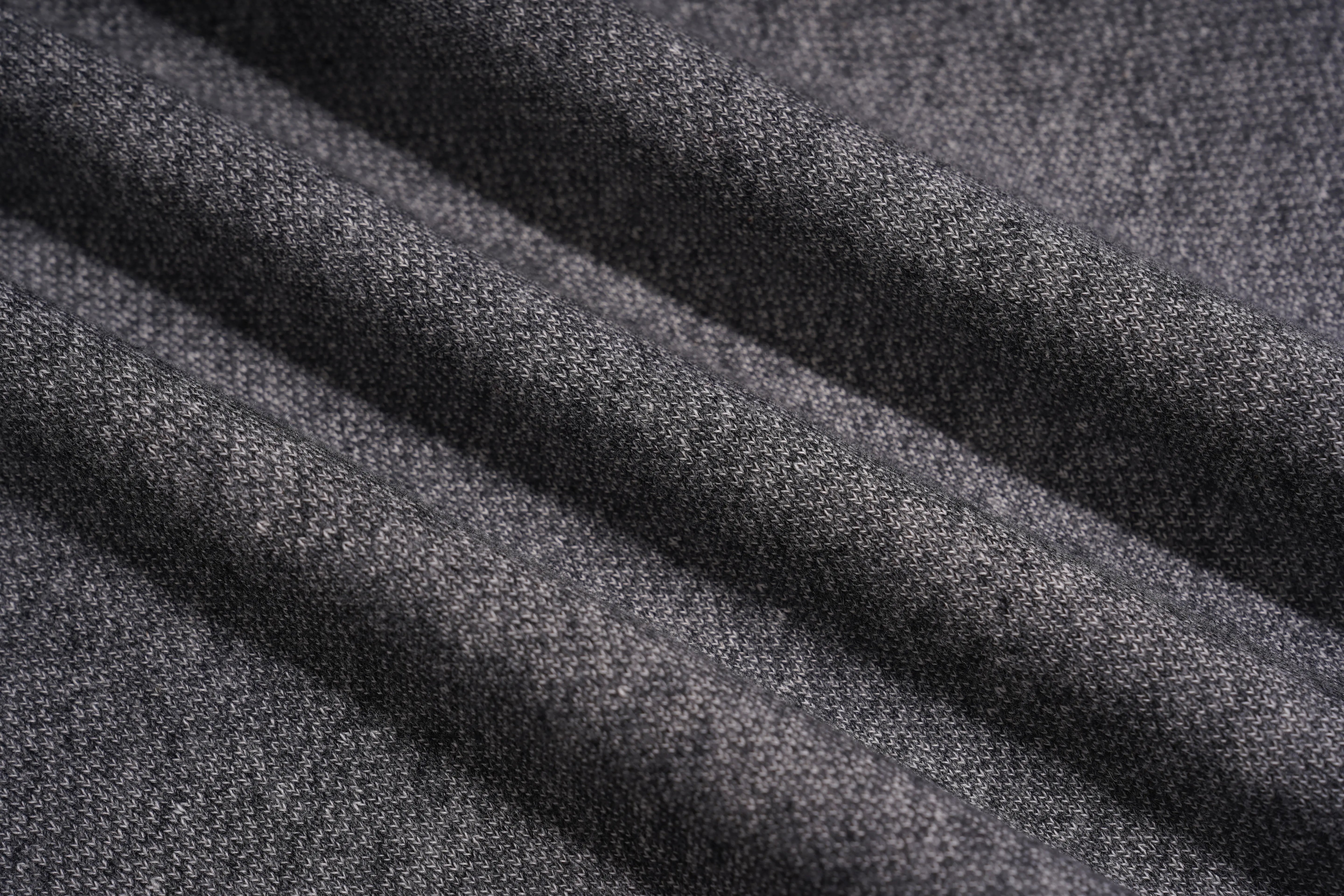 A close-up of dark charcoal gray textured fabric with soft diagonal folds showing the woven material detail. TCH Colorful Rhinestone Teddy Bear Crewneck Sweatshirt