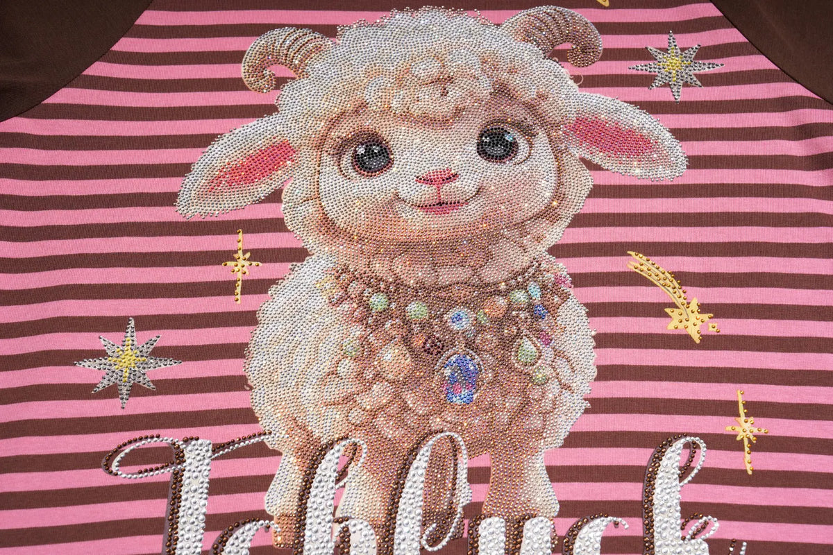 A close-up of a pink and dark brown striped garment featuring a large rhinestone applique of a cute, fluffy sheep with a jeweled collar, surrounded by small star and流星 embellishments. TCH Cute Lamb Pink Striped Raglan Long Sleeve Top