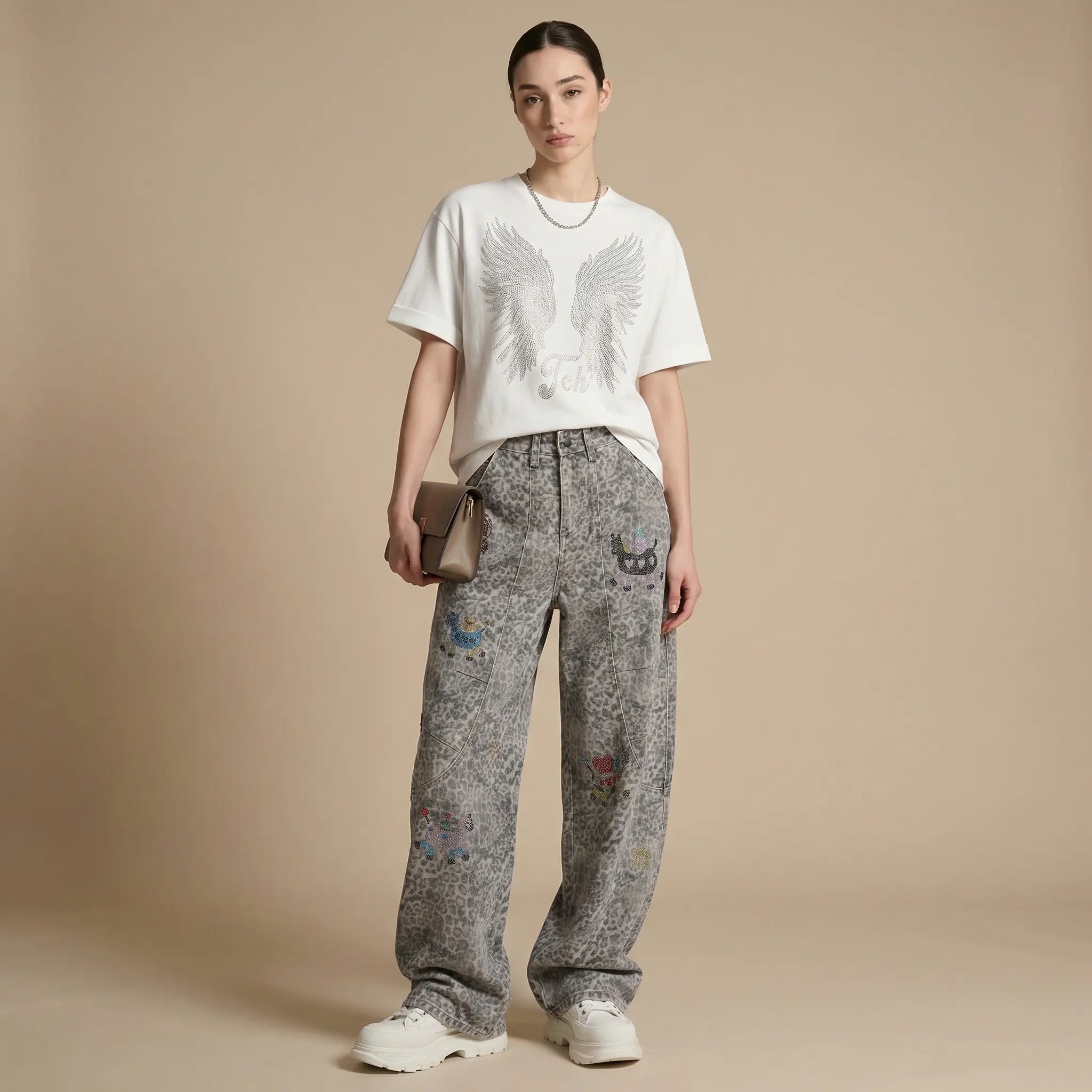 Person wearing a white t-shirt and patterned gray pants on a beige background, TCH Cute Pony Rhinestone Grey Leopard Wide-Leg Jeans