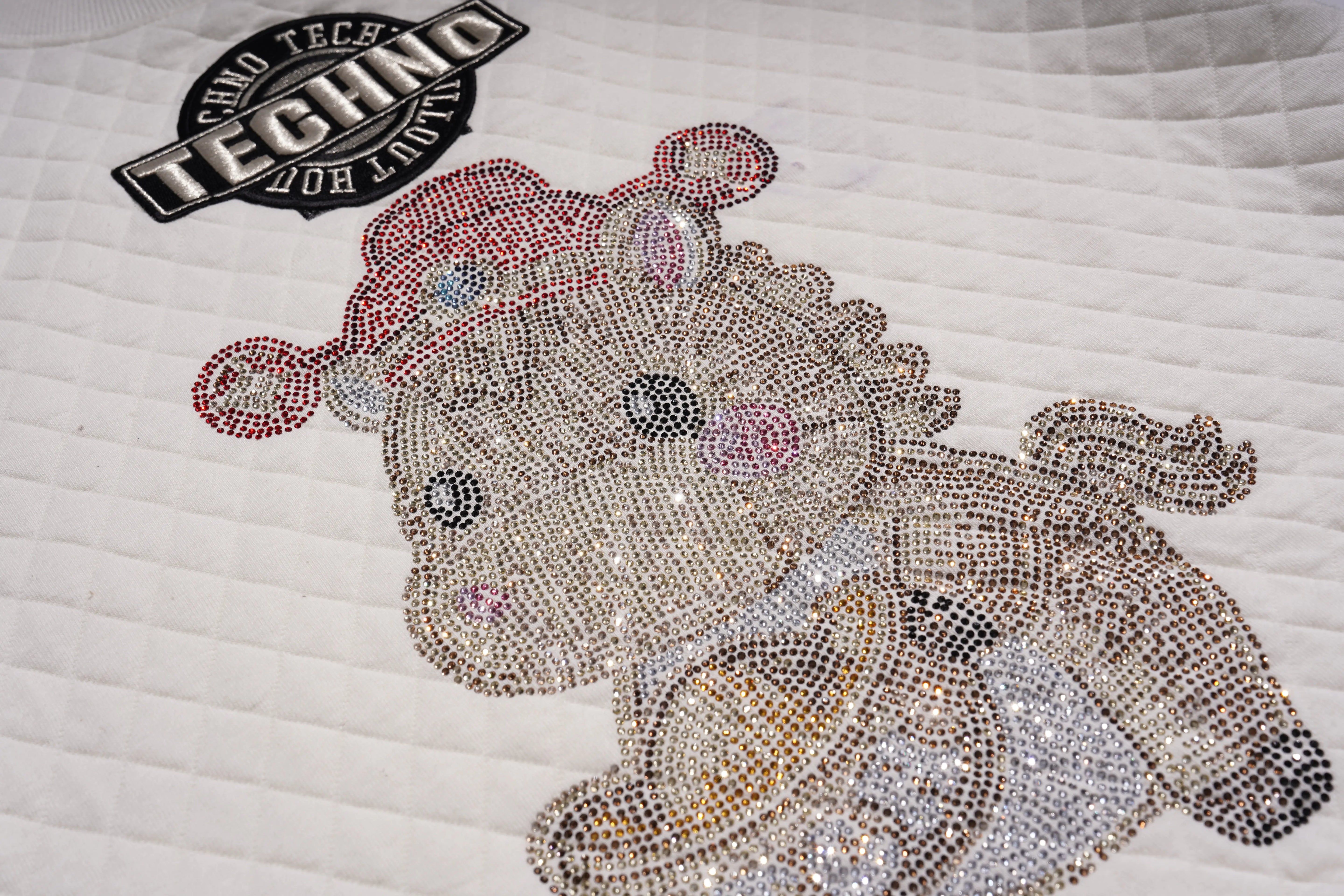 Decorative pillow with a teddy bear design made of rhinestones on a white quilted background. TCH Cute Rhinestone Fortune Pony Sweatshirt