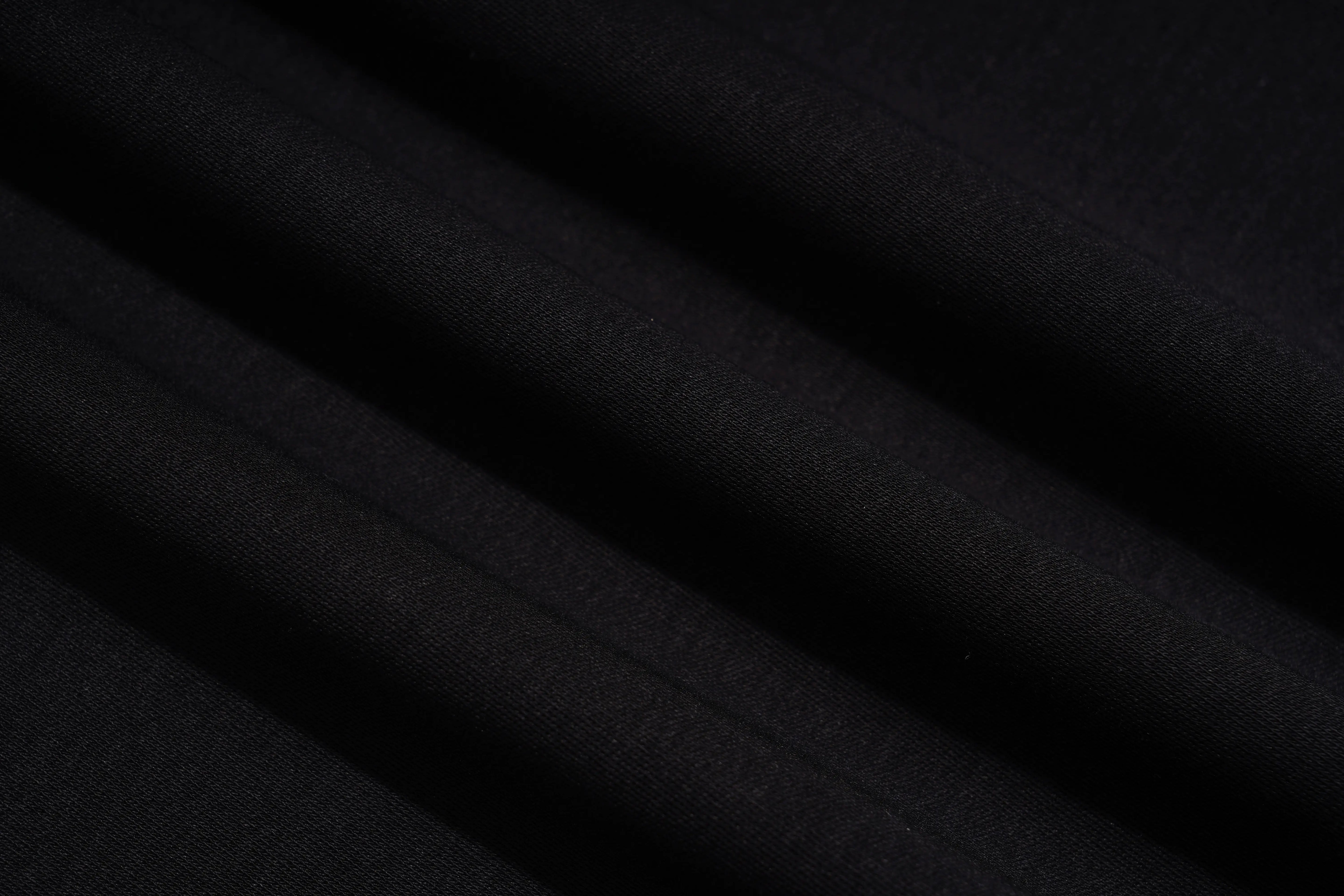 A close-up of draped black fabric with soft diagonal folds showing a fine woven texture. TCH Cute Teddy Bear Rhinestone Oversized T-Shirt Dress