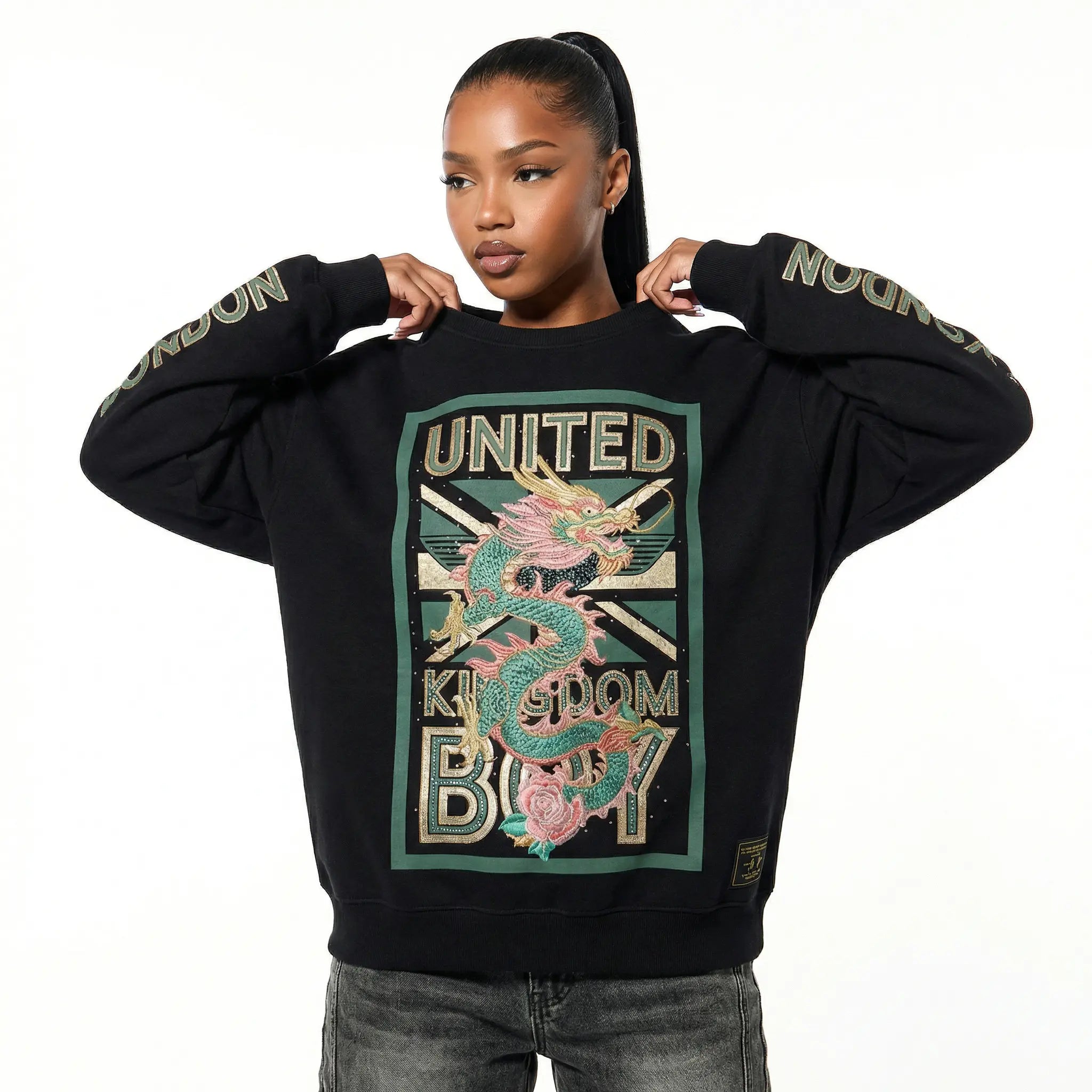 Person wearing a black sweatshirt with a dragon design and text on a white background, TCH Dragon Embroidered Rhinestone Sweatshirt-