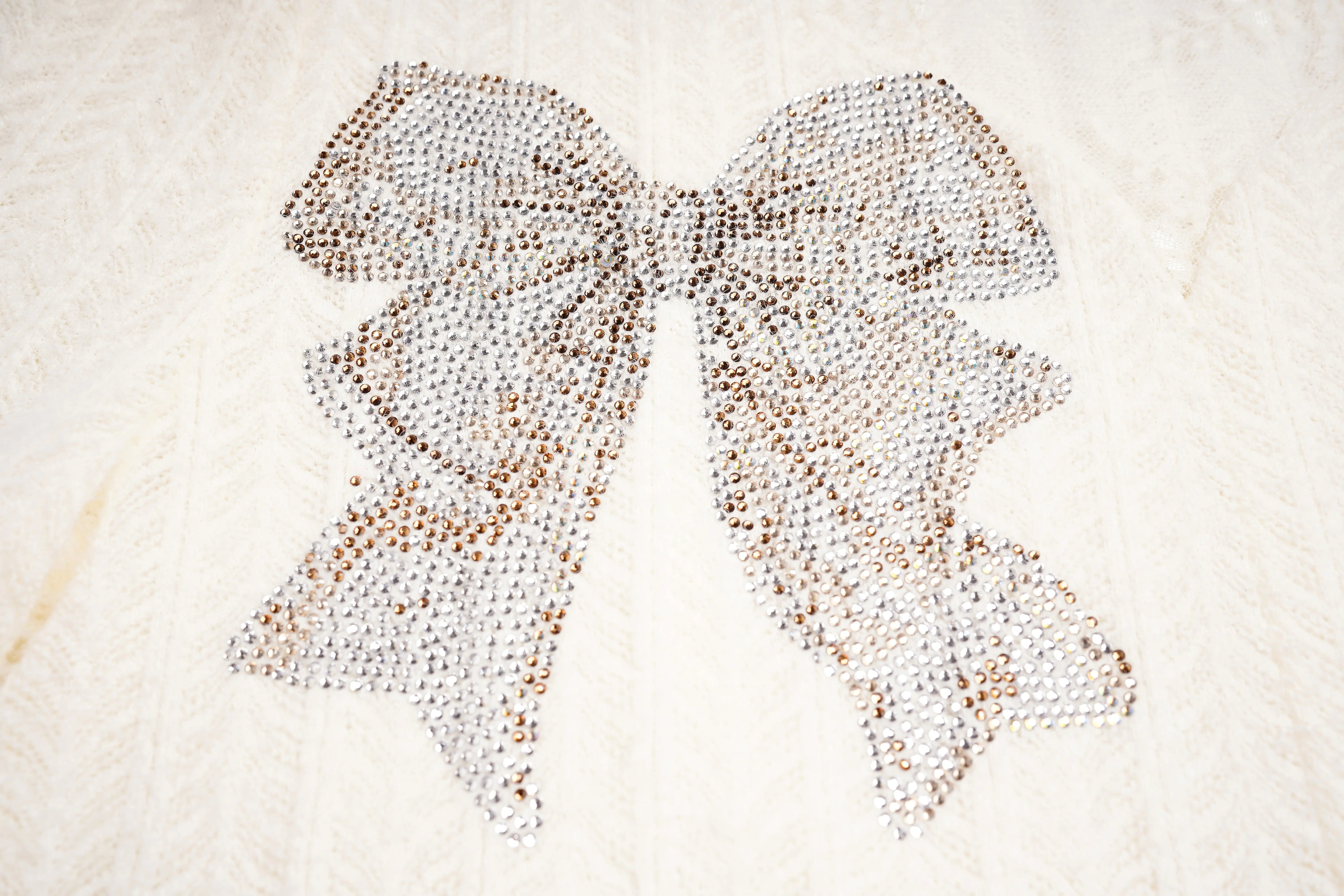 Butterfly-shaped pattern made of small round objects on a textured surface, TCH Dual-Layer Mesh V-Neck Rhinestone Bow Beige Crop Turtleneck Top
