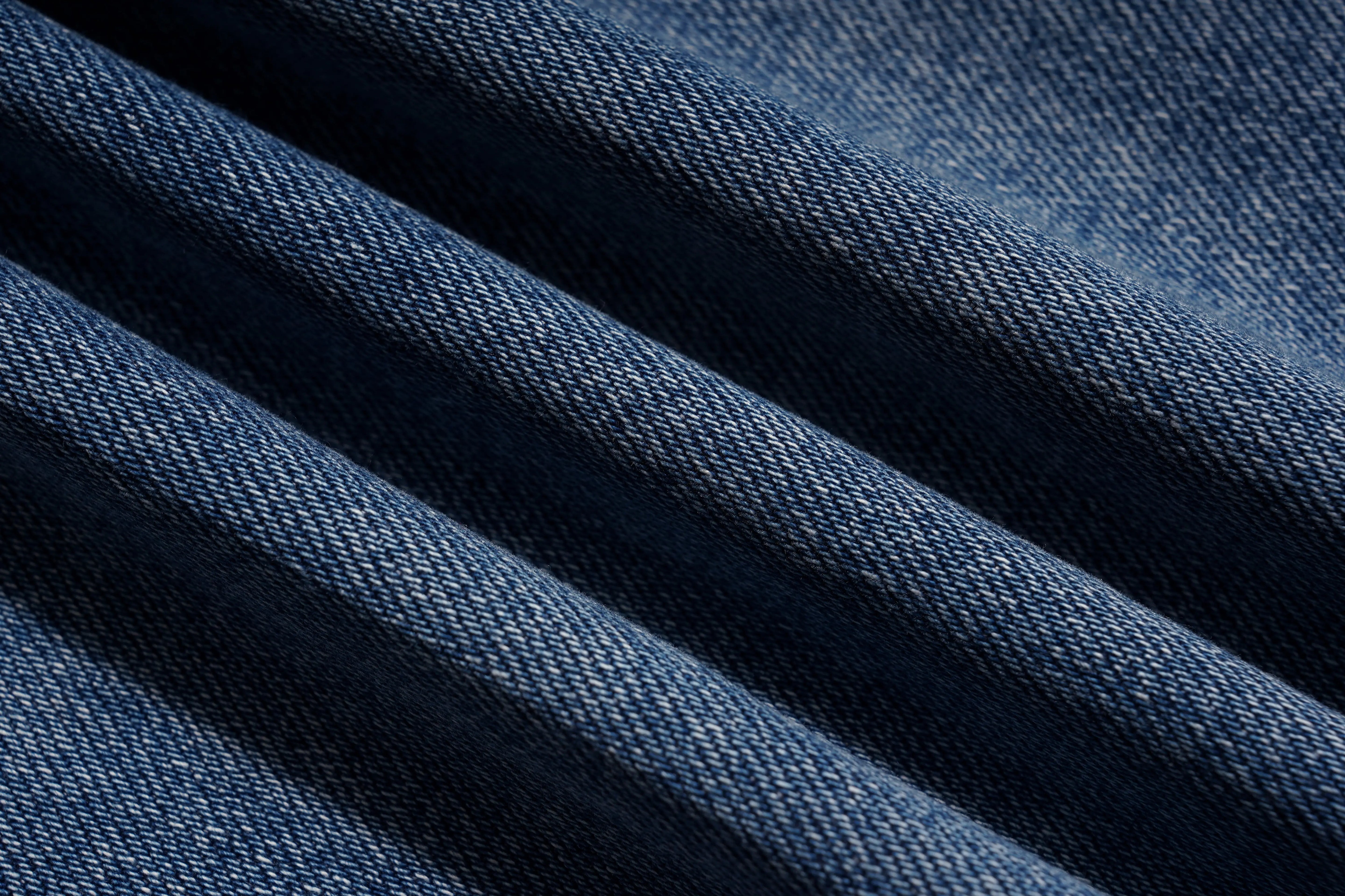 Close-up of blue denim fabric with visible texture, TCH Firework Star Rhinestone Straight-Leg Blue Jeans