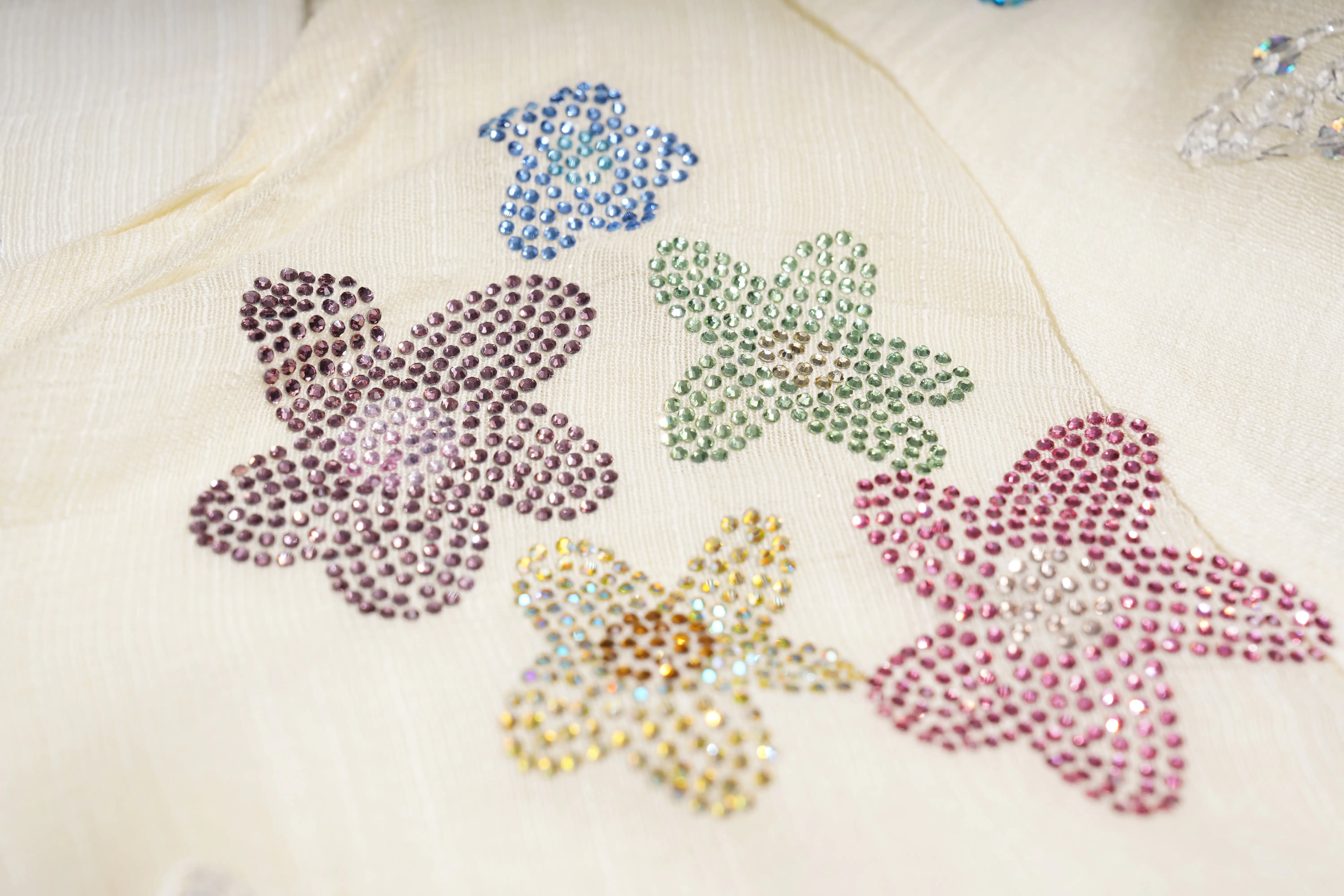 Decorative flowers made of colorful rhinestones on a light fabric background, TCH Floral Rhinestone Embellished V-Neck Blouse