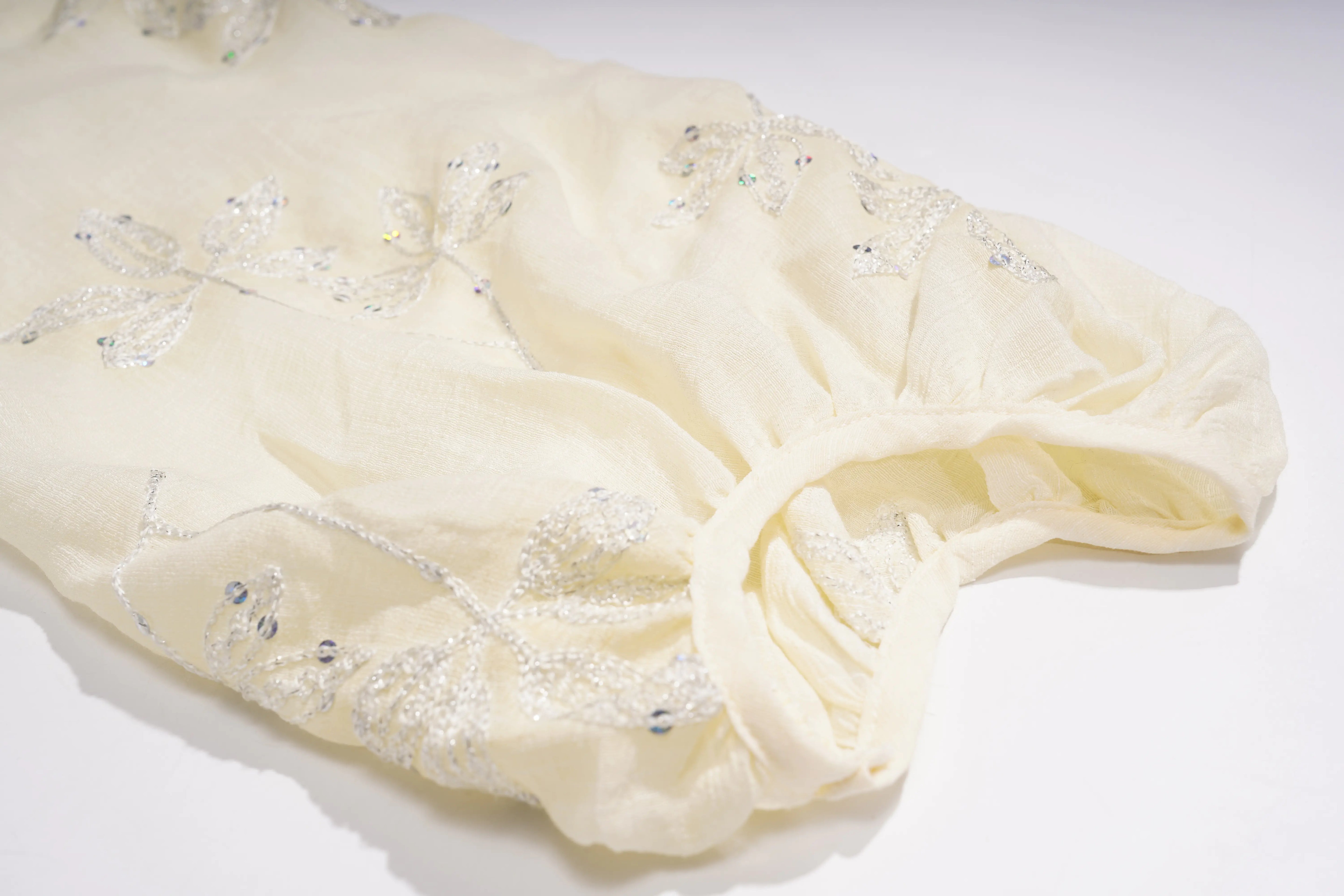 Cream-colored fabric with bead embellishments on a white background, TCH Floral Rhinestone Embellished V-Neck Blouse