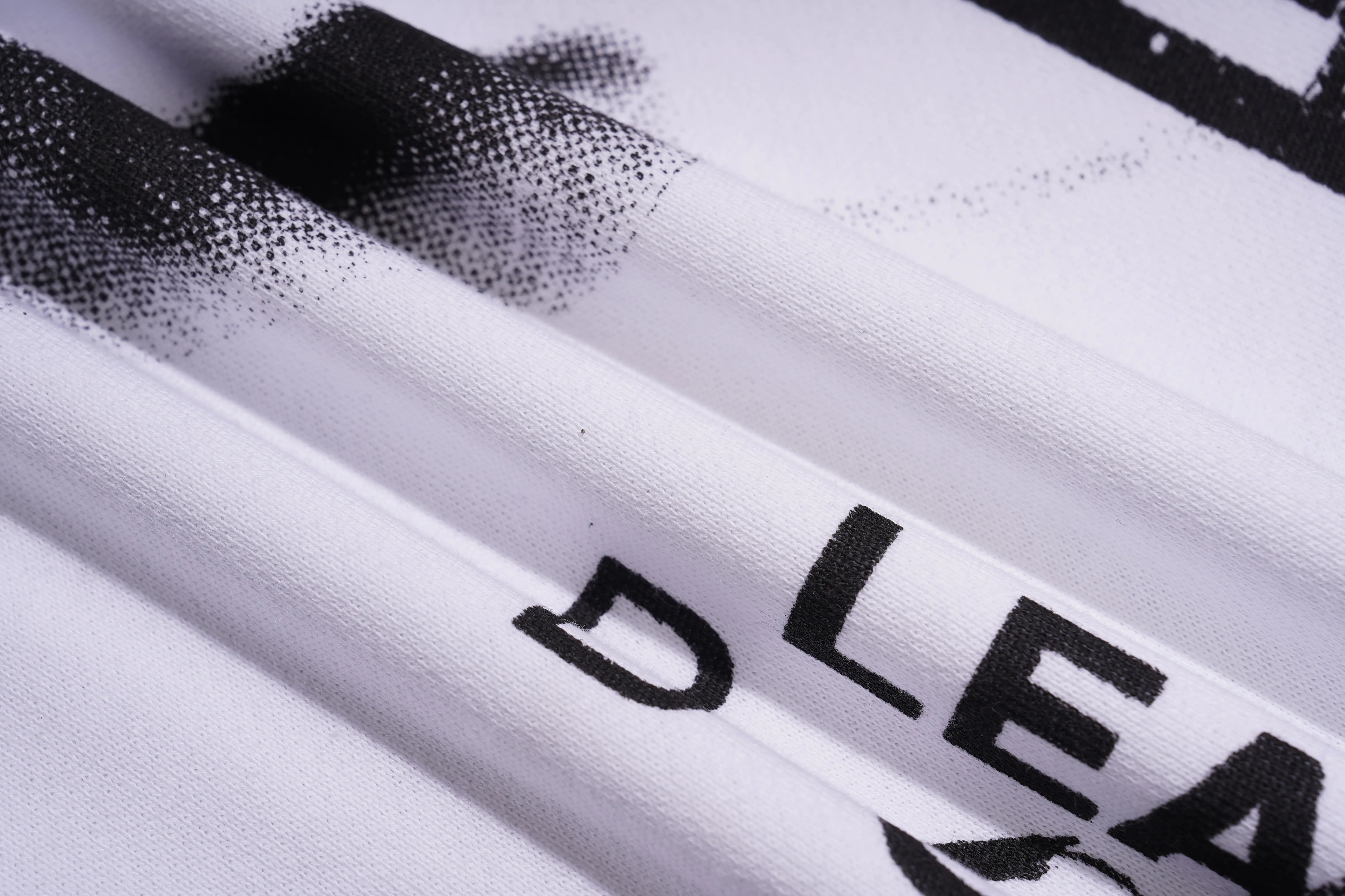 Close-up of a white fabric with black text and design elements. TCH Graffiti Logo Print Crewneck Sweatshirt