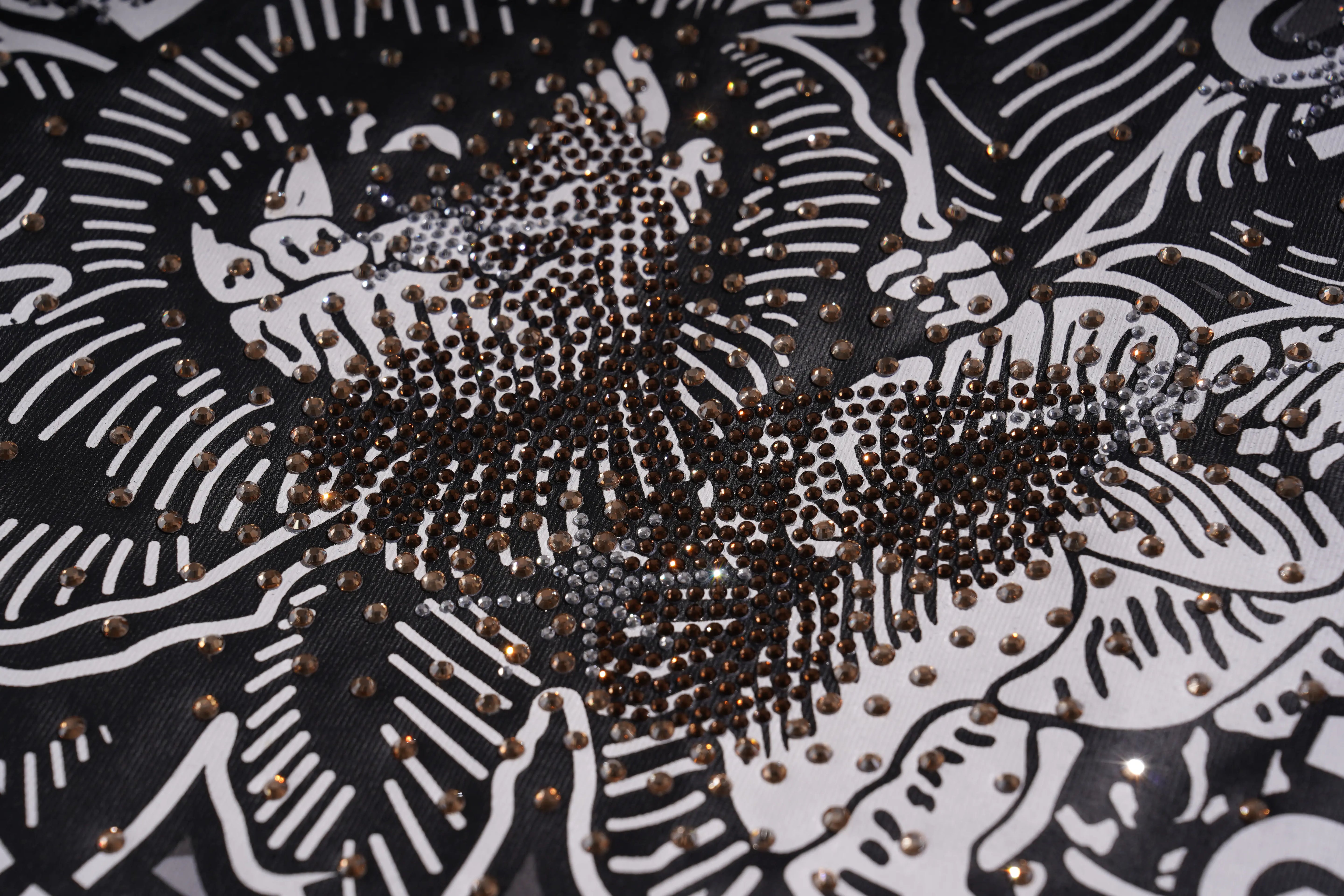 Close-up of a black and white patterned fabric with gold embellishments, TCH Graphic Rhinestone Heat Transfer Crewneck Sweatshirt-