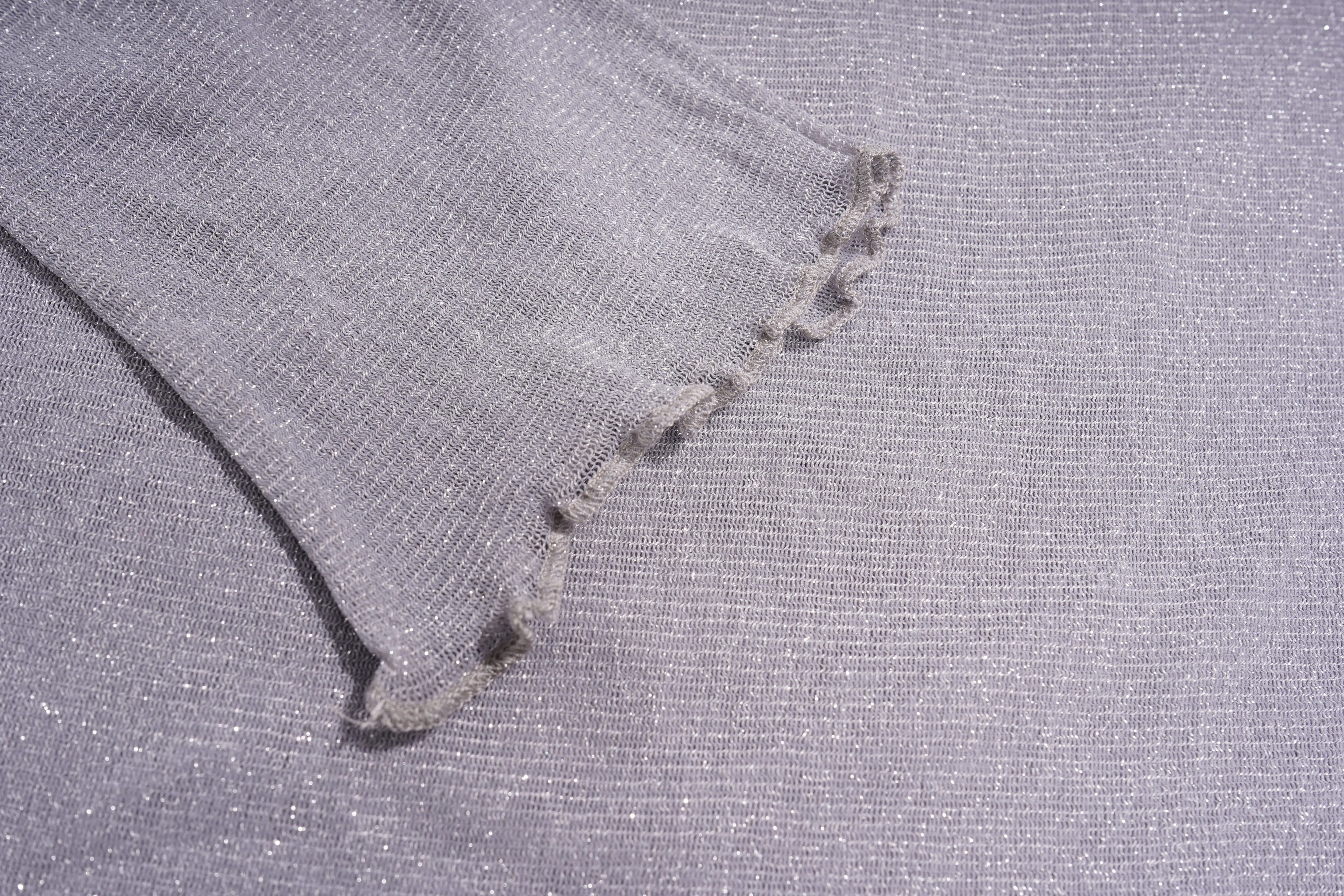 Close-up of gray fabric with a textured pattern, TCH Grey Rhinestone Purple Wings Long Sleeve Top
