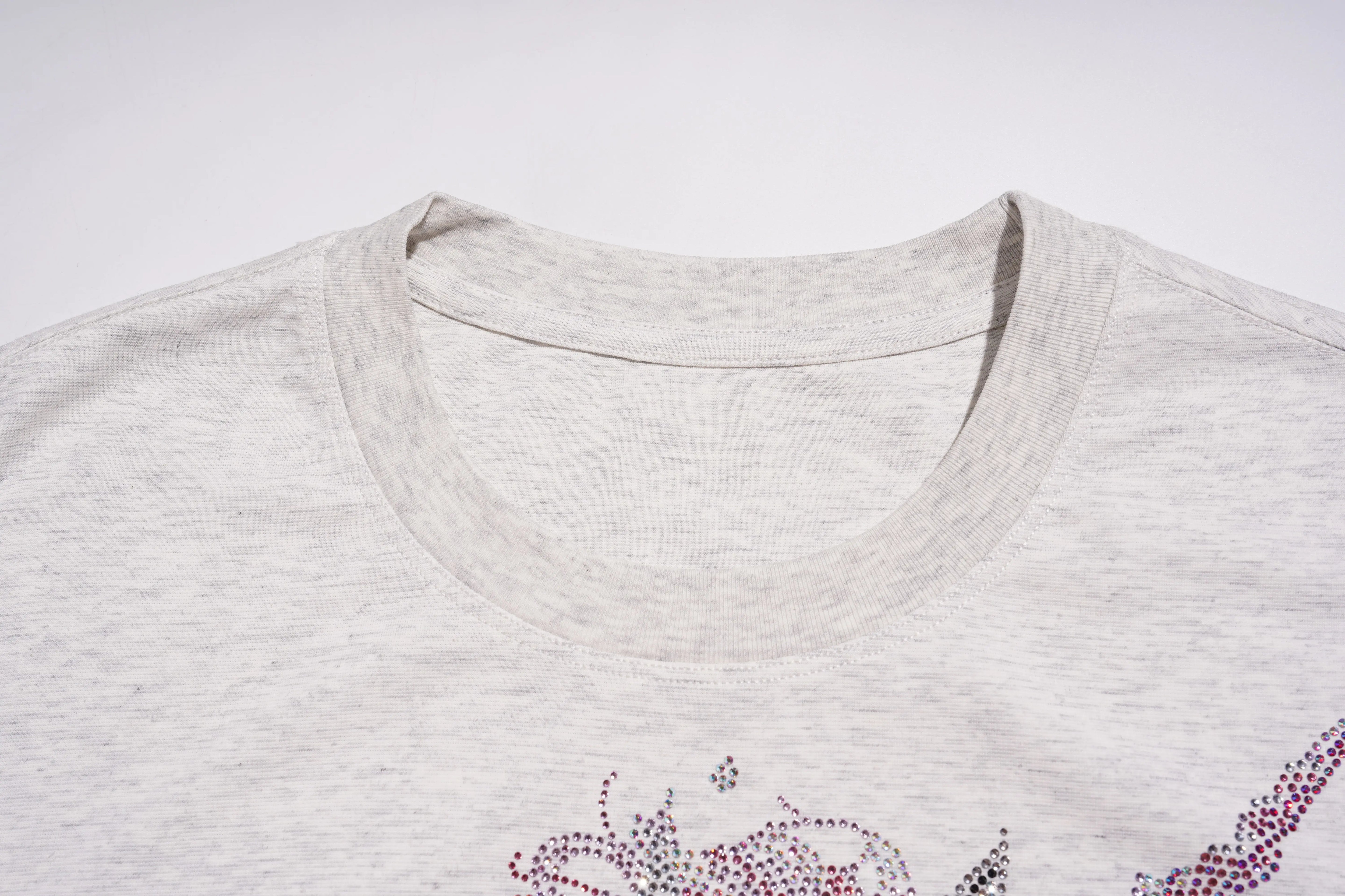 Close-up of a gray t-shirt with a floral embellishment on a white background, TCH Grey Rhinestone Unicorn Graphic T-Shirt