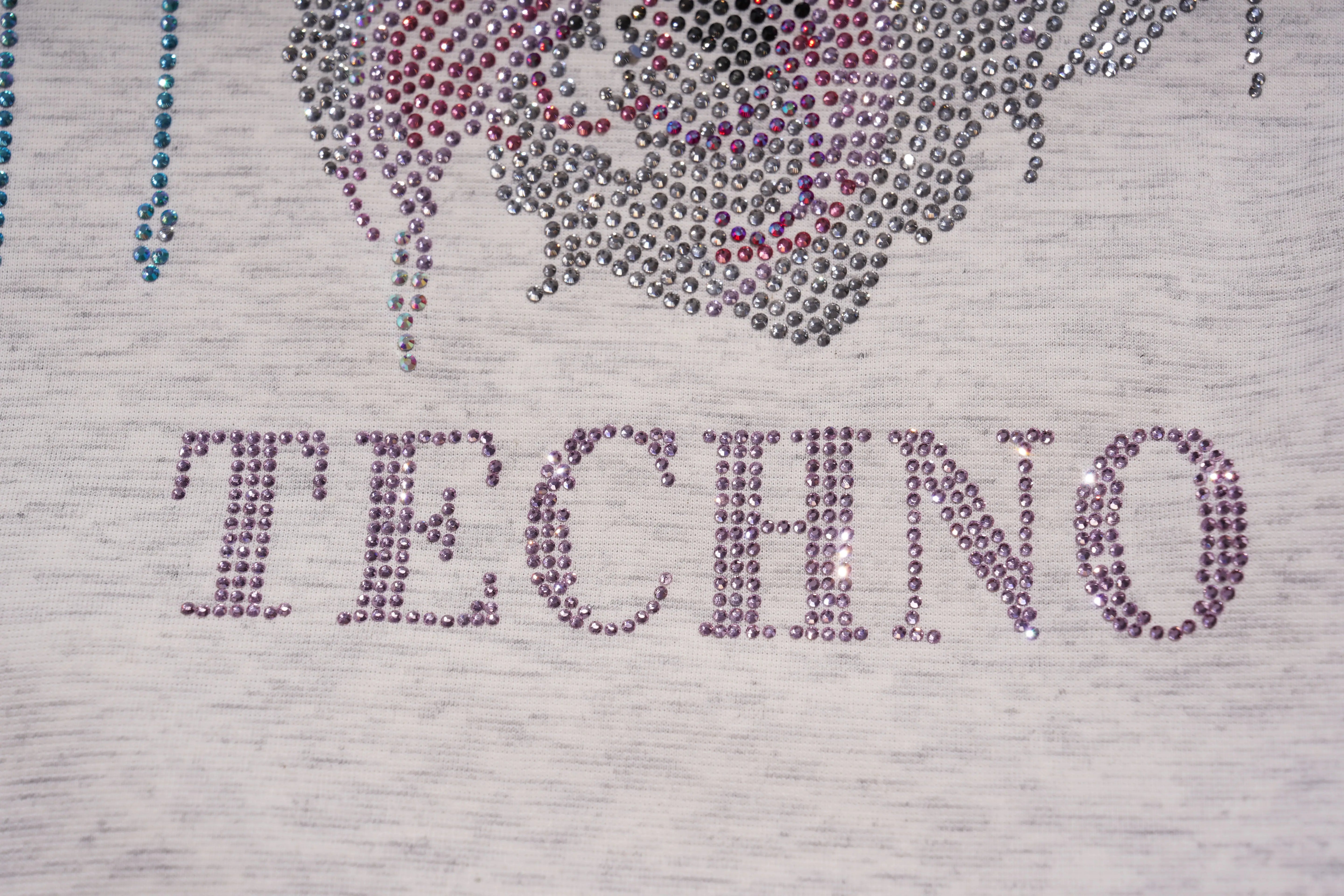 Text 'TECHNO' made of rhinestones on a textured surface, TCH Grey Rhinestone Unicorn Graphic T-Shirt