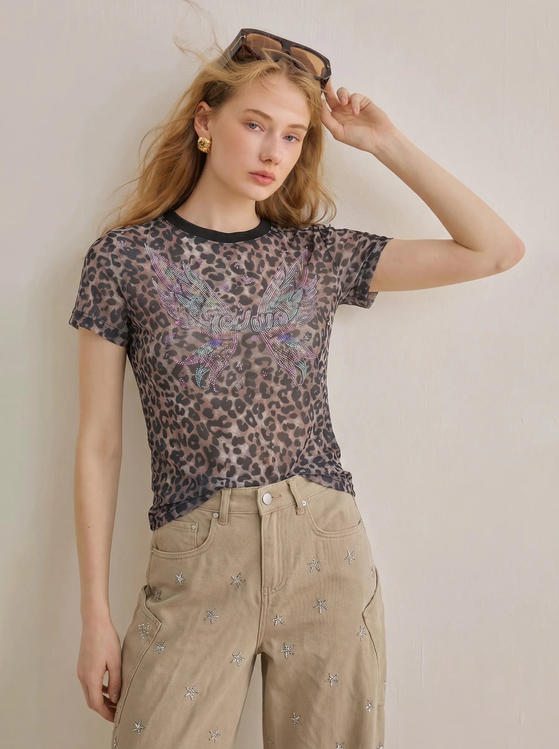 Woman wearing a sheer leopard print top with embroidered details against a plain background, TCH Leopard Print Rhinestone Butterfly Fitted T-Shirt