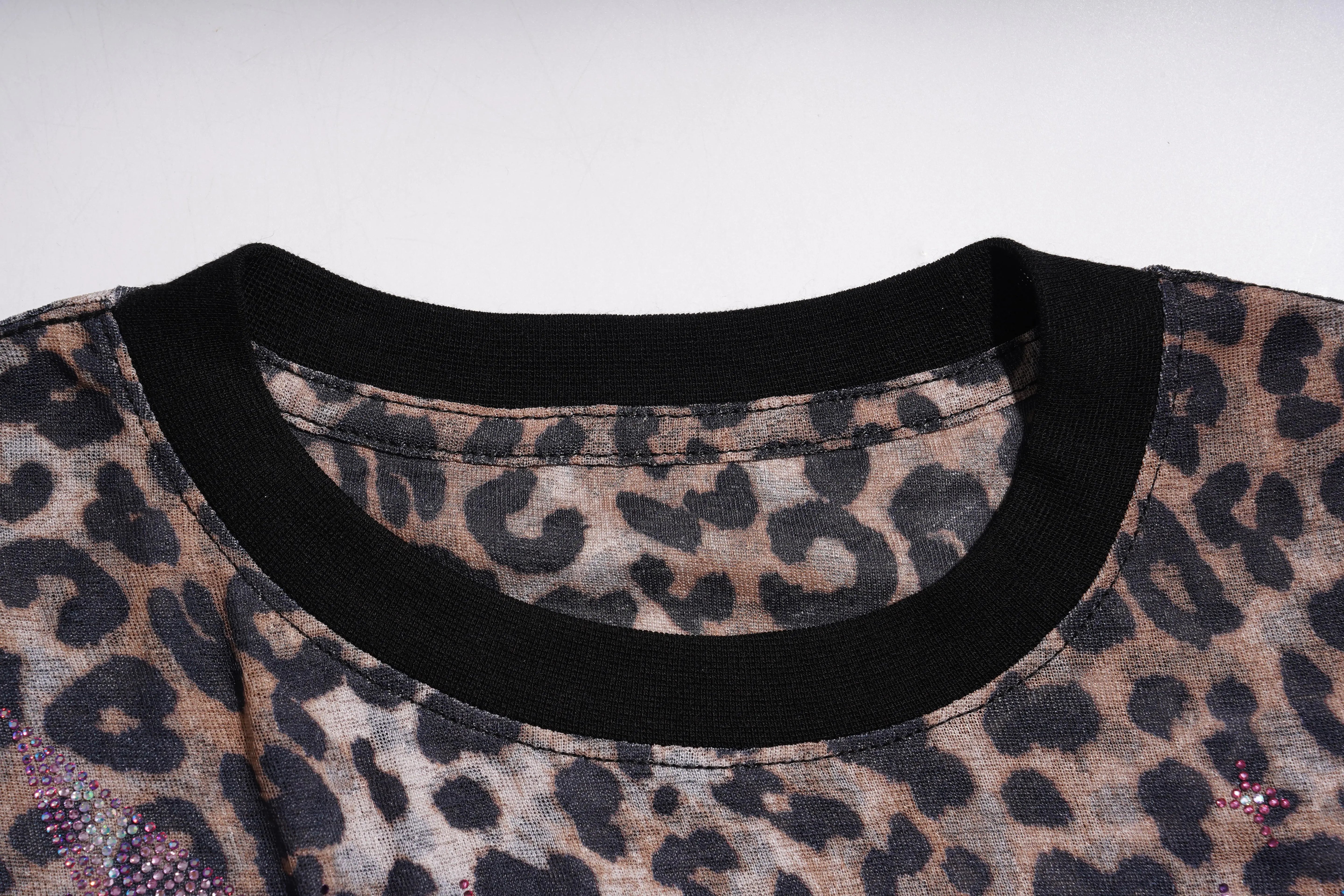 Close-up of a leopard print garment with a black neckline on a white background, TCH Leopard Print Rhinestone Butterfly Fitted T-Shirt