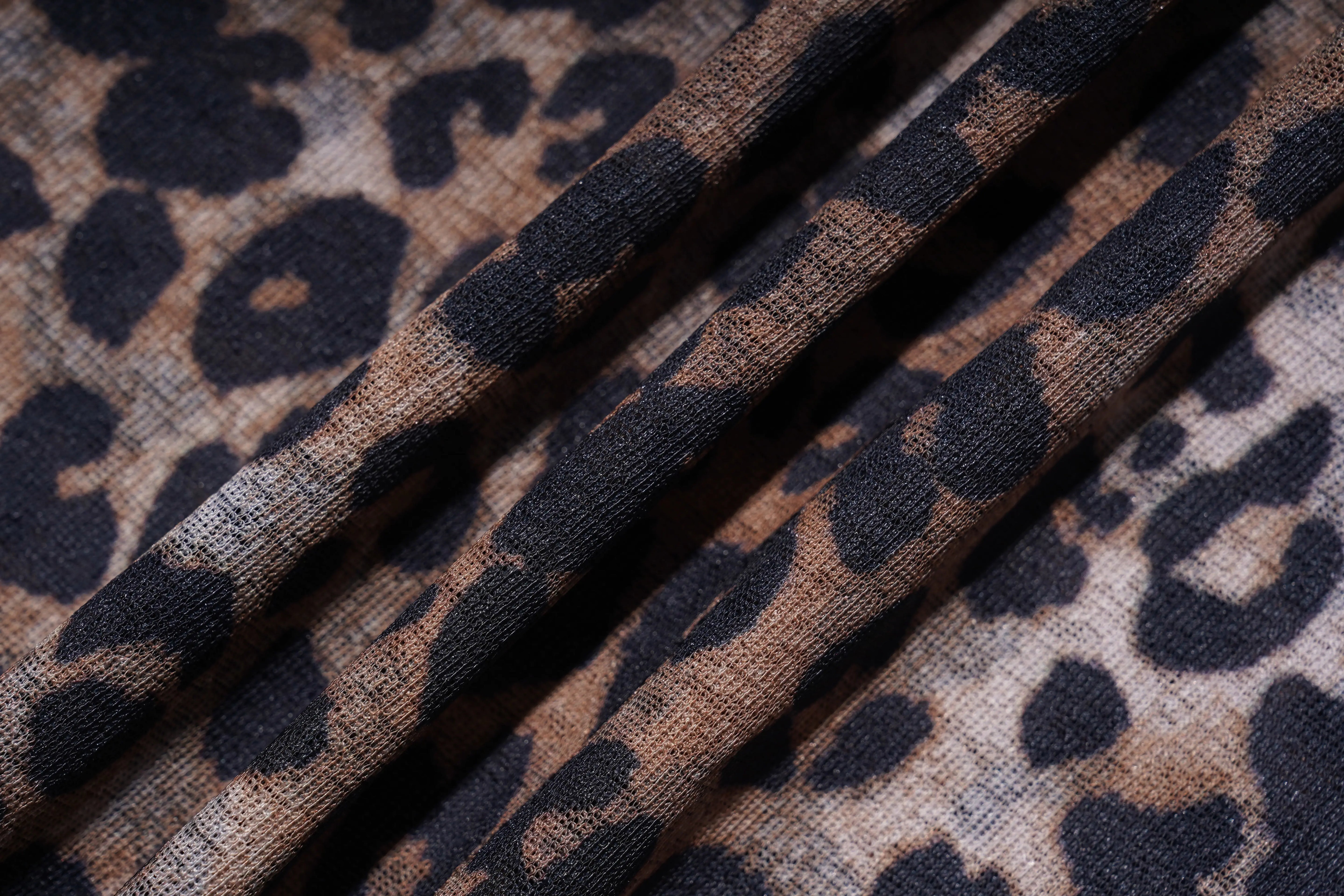 Leopard print fabric with a close-up view of the pattern. TCH Leopard Print Rhinestone Butterfly Fitted T-Shirt