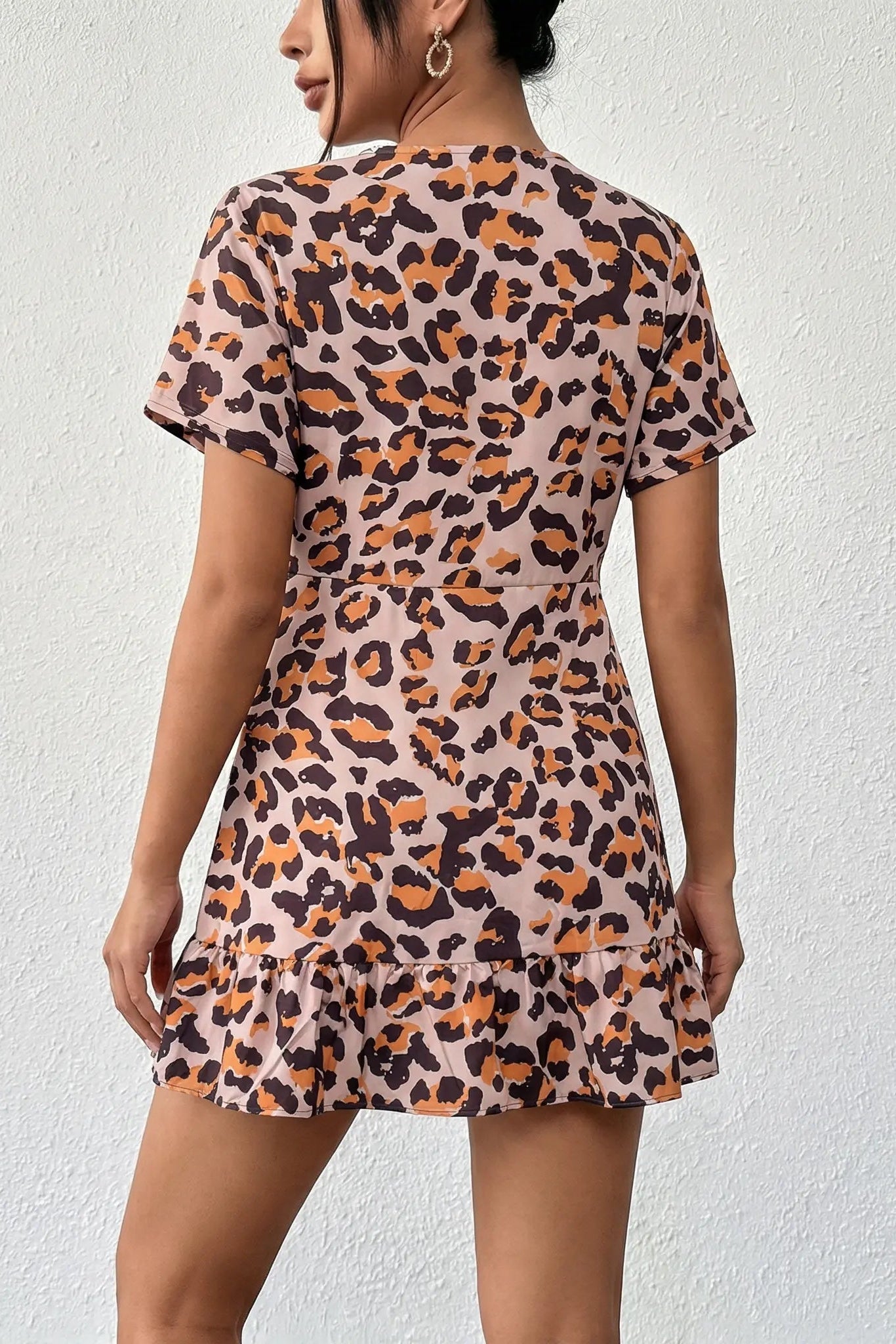 Woman wearing a leopard print dress against a white background, TCH Leopard Rhinestone Animal Embellished Dress