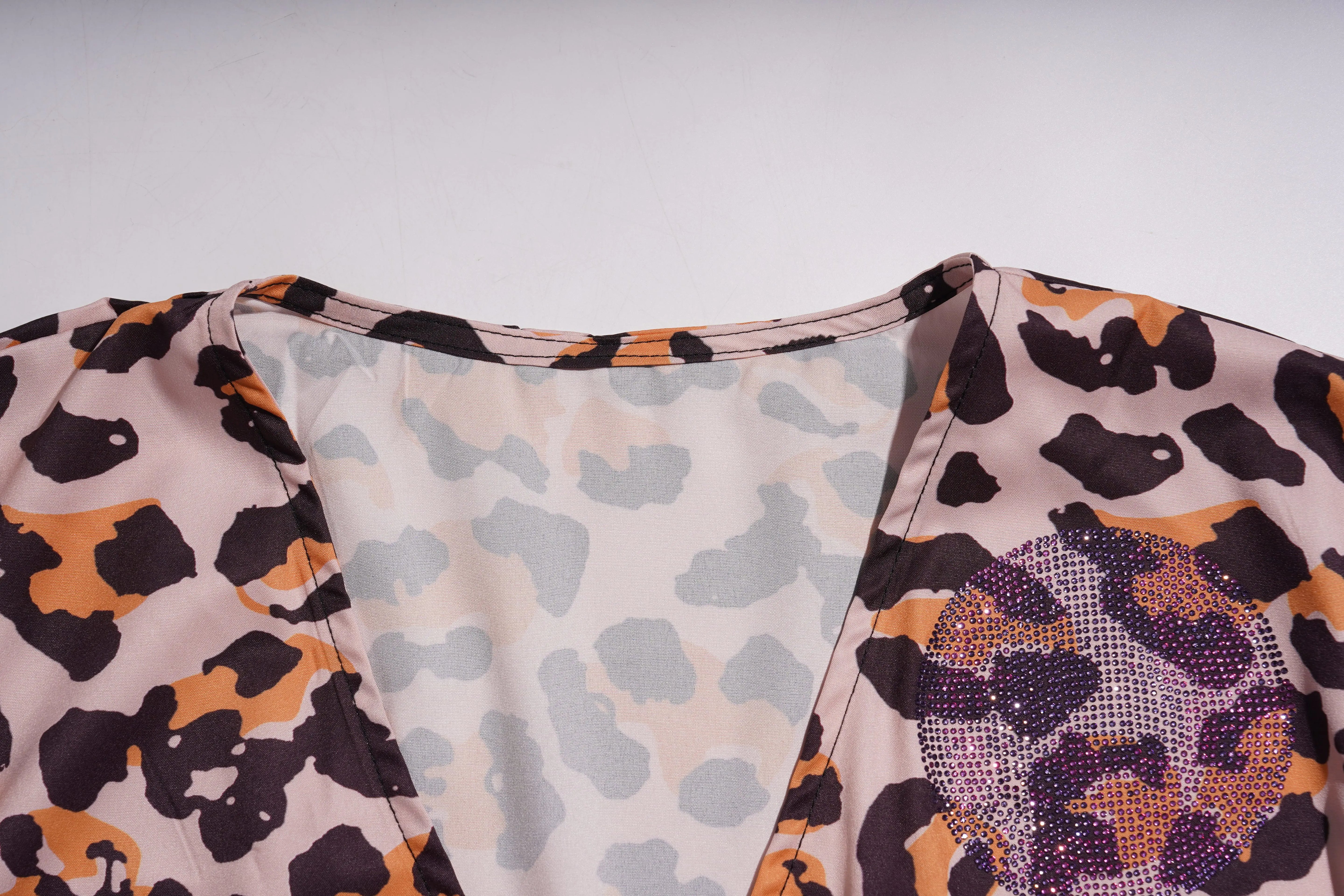 Close-up of fabric with leopard print and abstract pattern on a white background, TCH Leopard Rhinestone Animal Embellished Dress