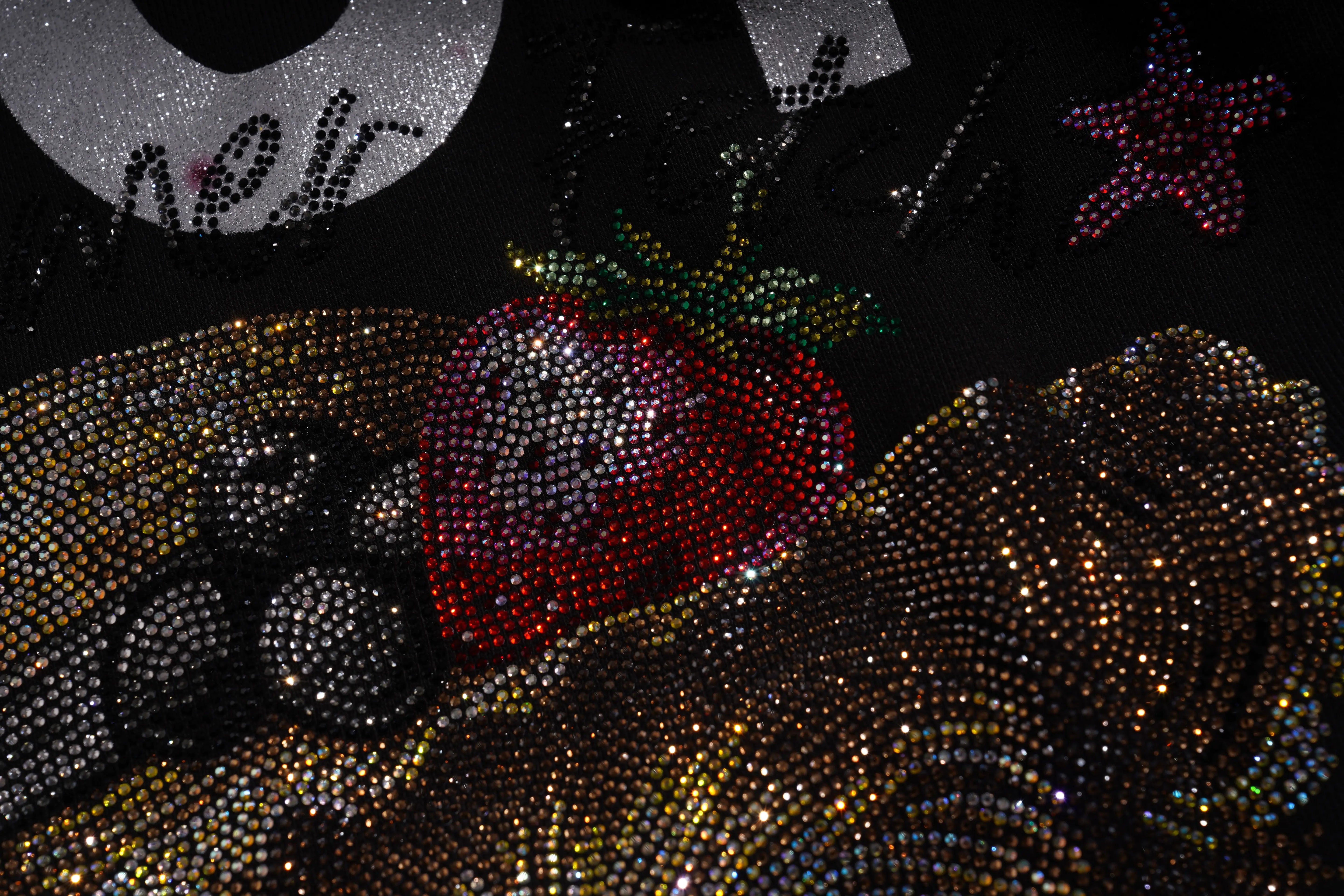 Decorative items including a red heart, black berries, and a gold bow on a dark background. TCH Luck Dog Rhinestone Hooded Sweatshirt
