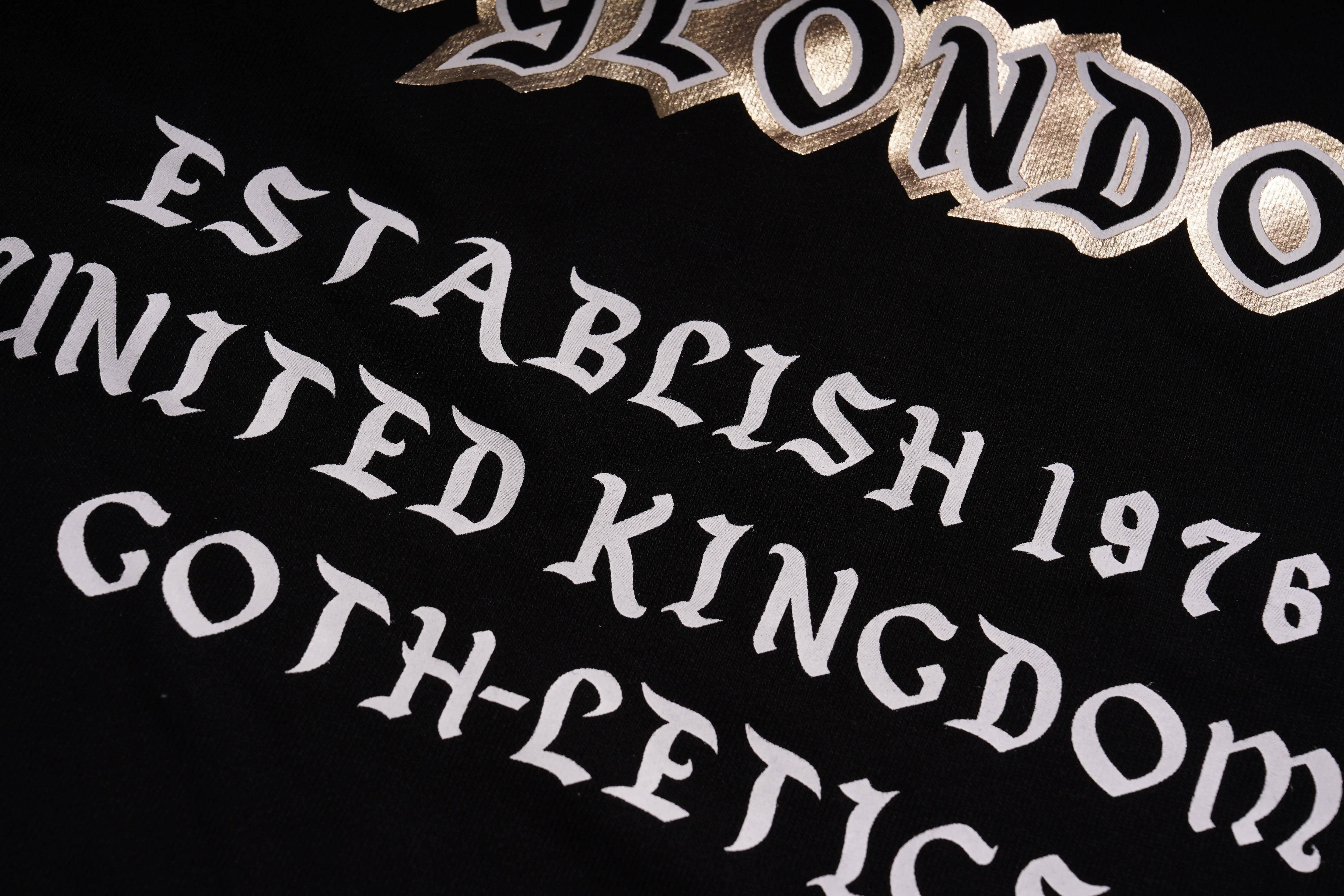 Text on a black background with 'Goth-Letics' branding. TCH Lucky Pig Rhinestone Sweatshirt
