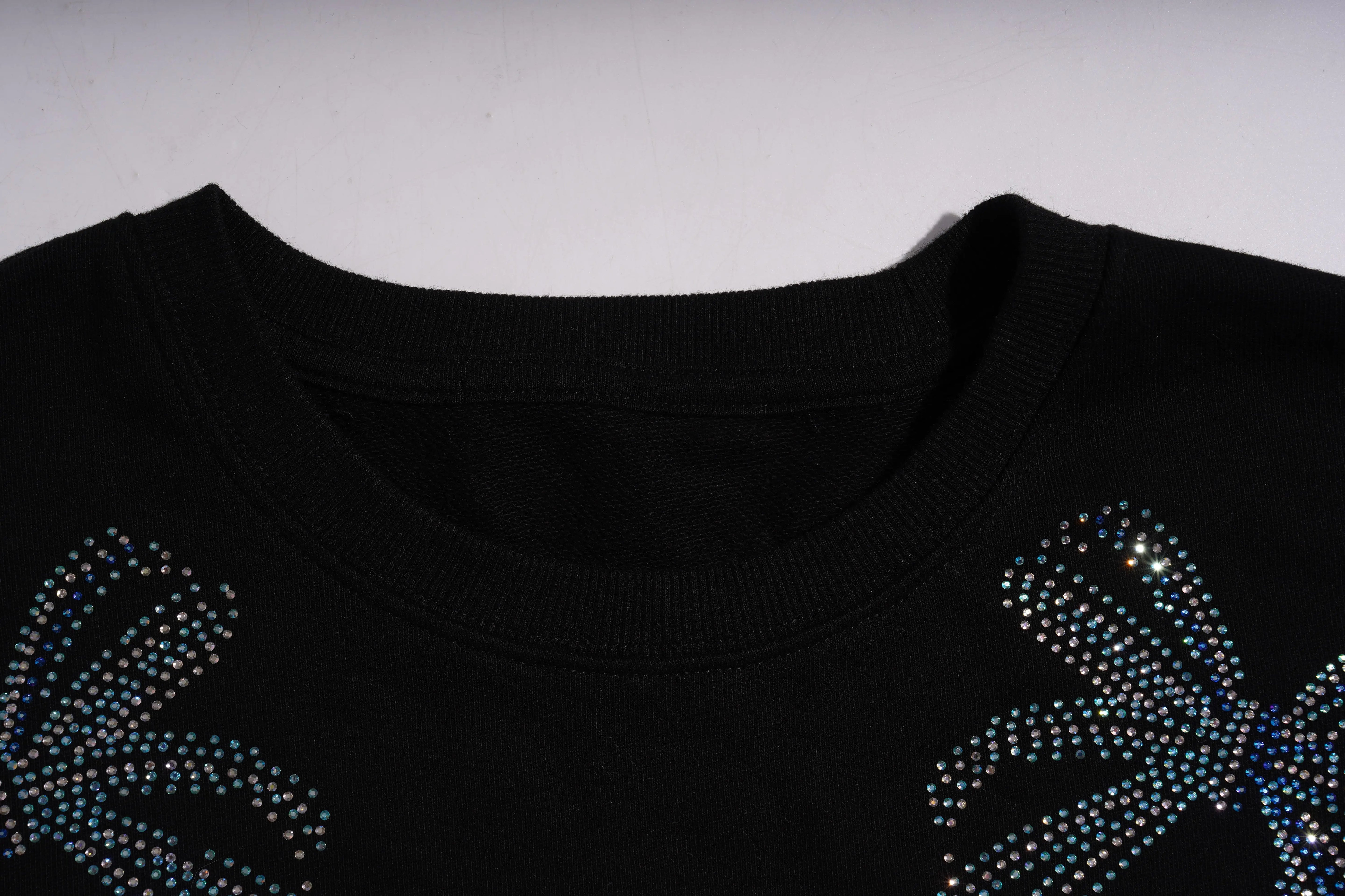 Black garment with blue rhinestone designs on a white background, TCH Lucky Pig Rhinestone Sweatshirt