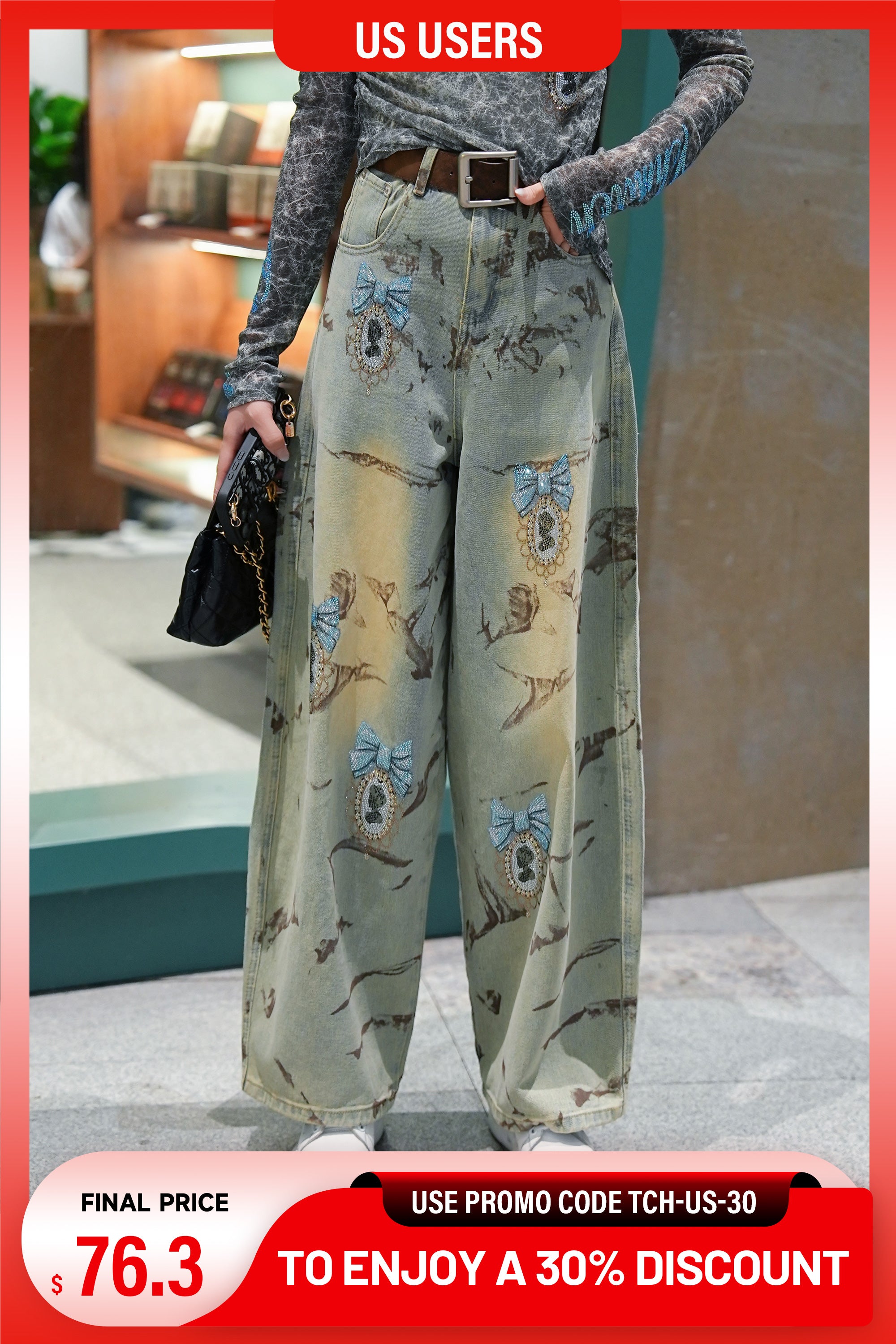 Person wearing white pants with blue text design in a room. TCH Marble Mirage Rhinestone Mirror Wide-Leg Jeans