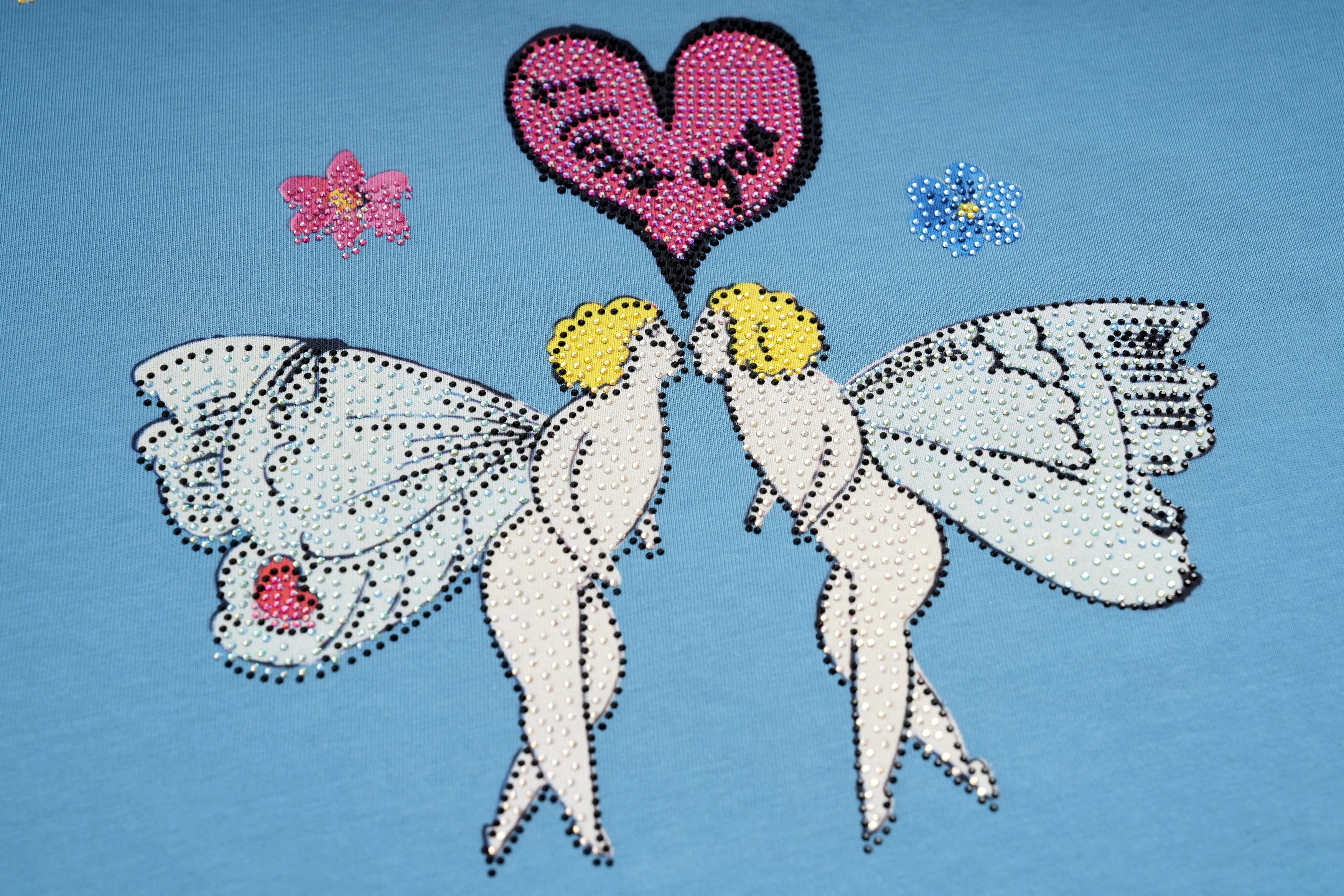 Decorative design of two fairies with a heart-shaped balloon on a blue background, TCH My Baby Rhinestone Bear Oversized Blue T-Shirt