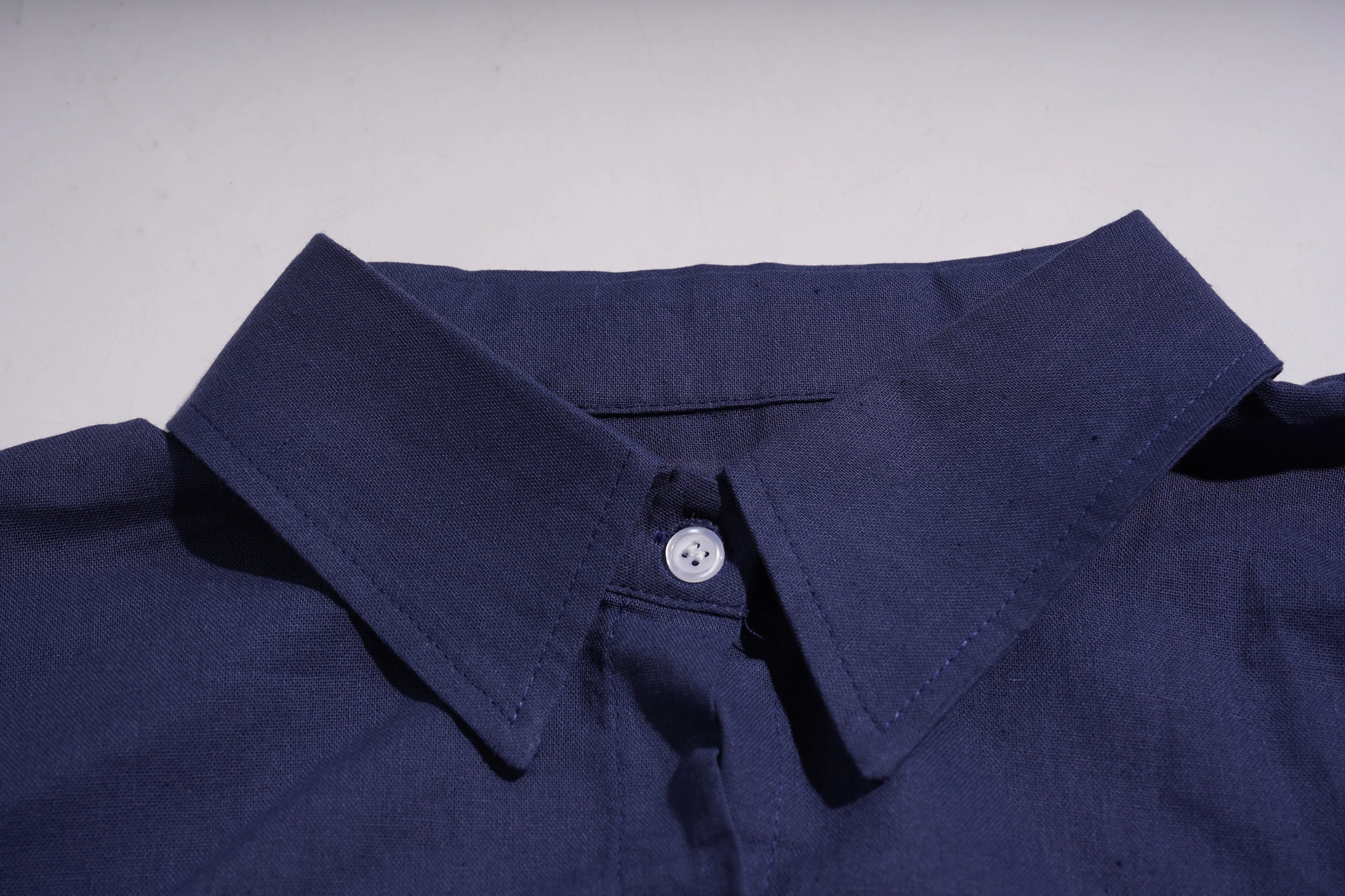 Close-up of a navy blue shirt collar with a button on a light gray background, TCH Navy Rhinestone Dog Matching Set