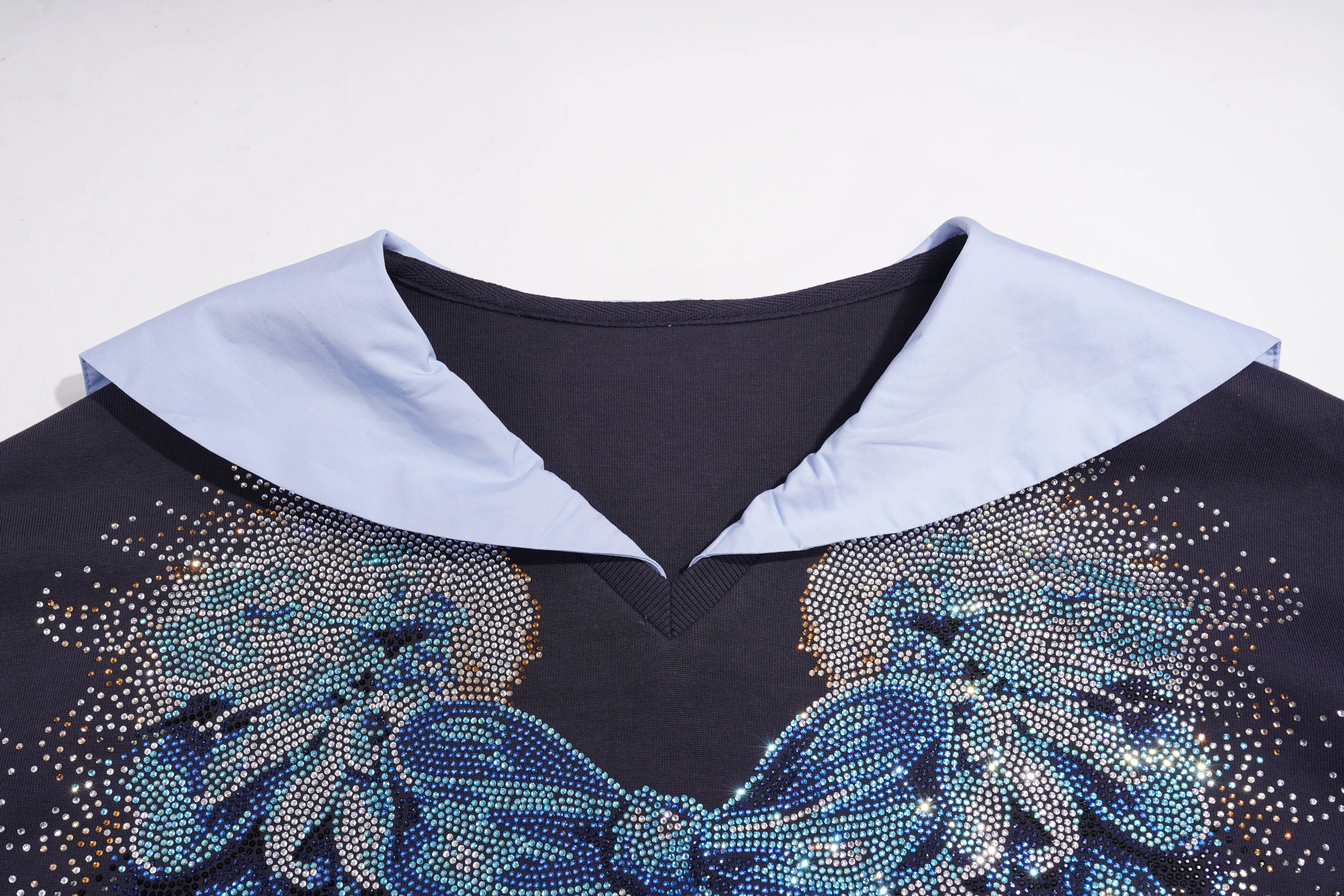 Close-up of a black garment with blue floral embellishments and light blue collar on a white background, TCH Navy Sailor Bow Wings Rhinestone Two-Piece Set