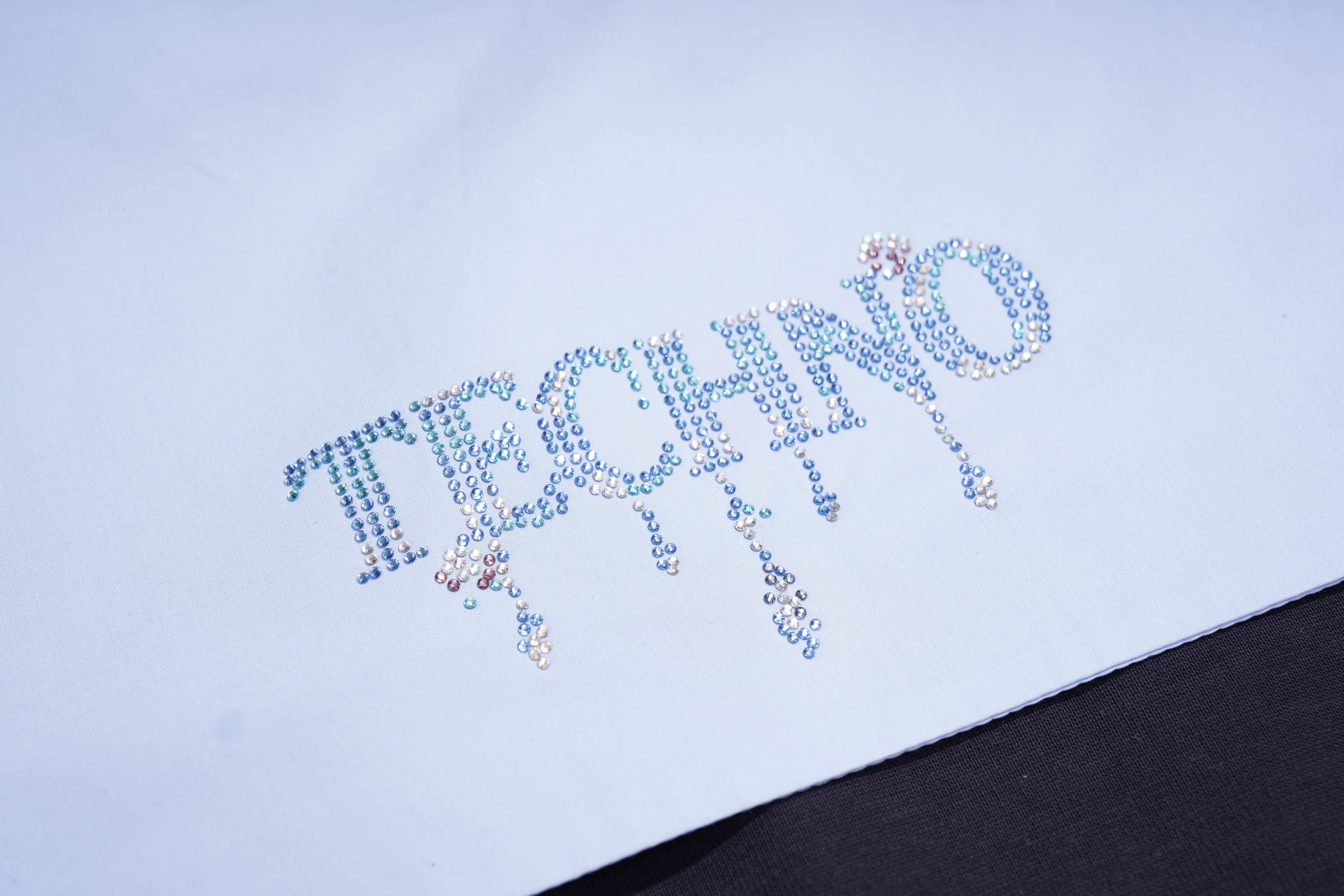 Text 'THE CHANGING' made of small colorful beads on a light blue background, TCH Navy Sailor Bow Wings Rhinestone Two-Piece Set