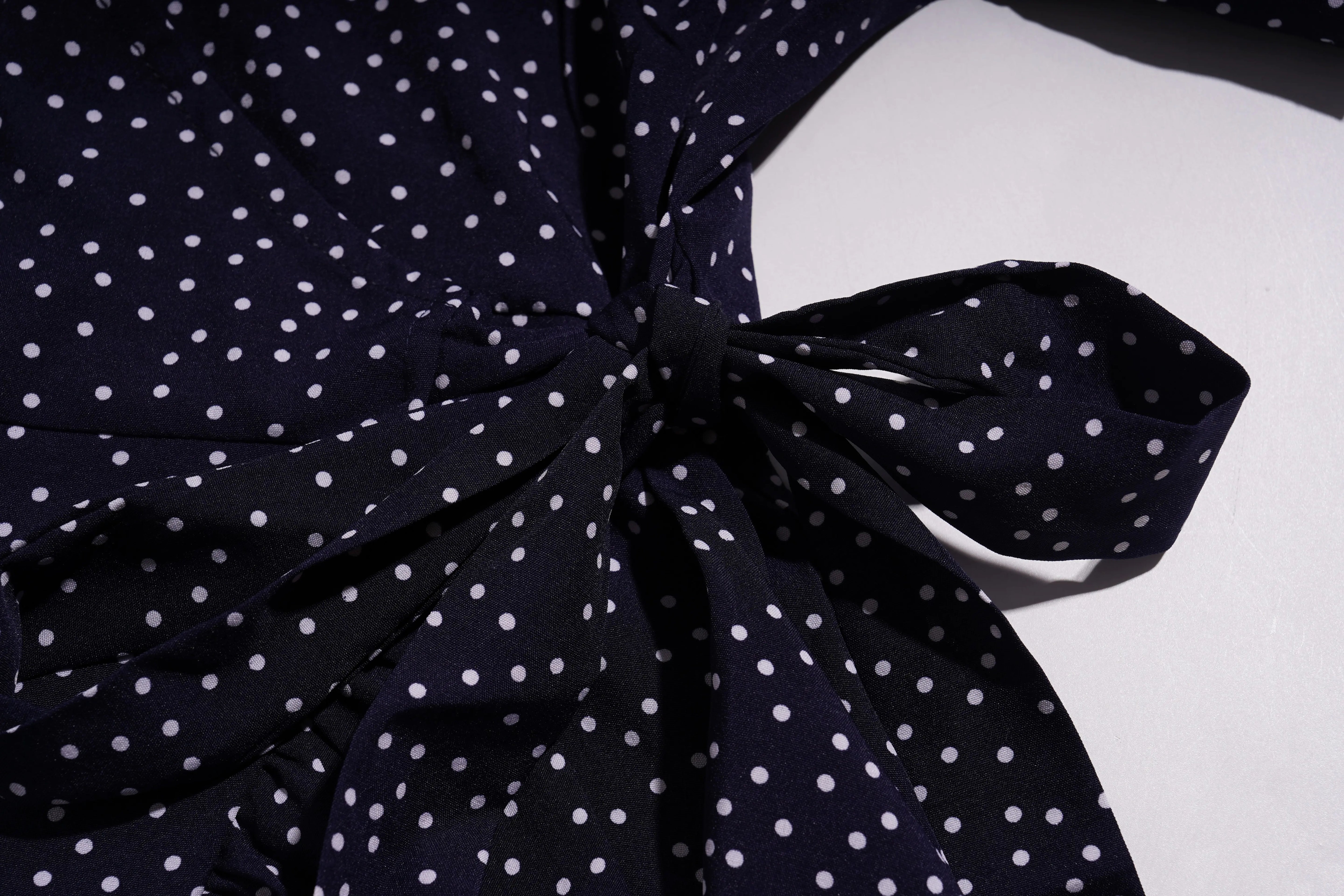 Navy blue polka dot dress with a large bow on a white background, TCH Navy Teddy Bear Bow Rhinestone Dress