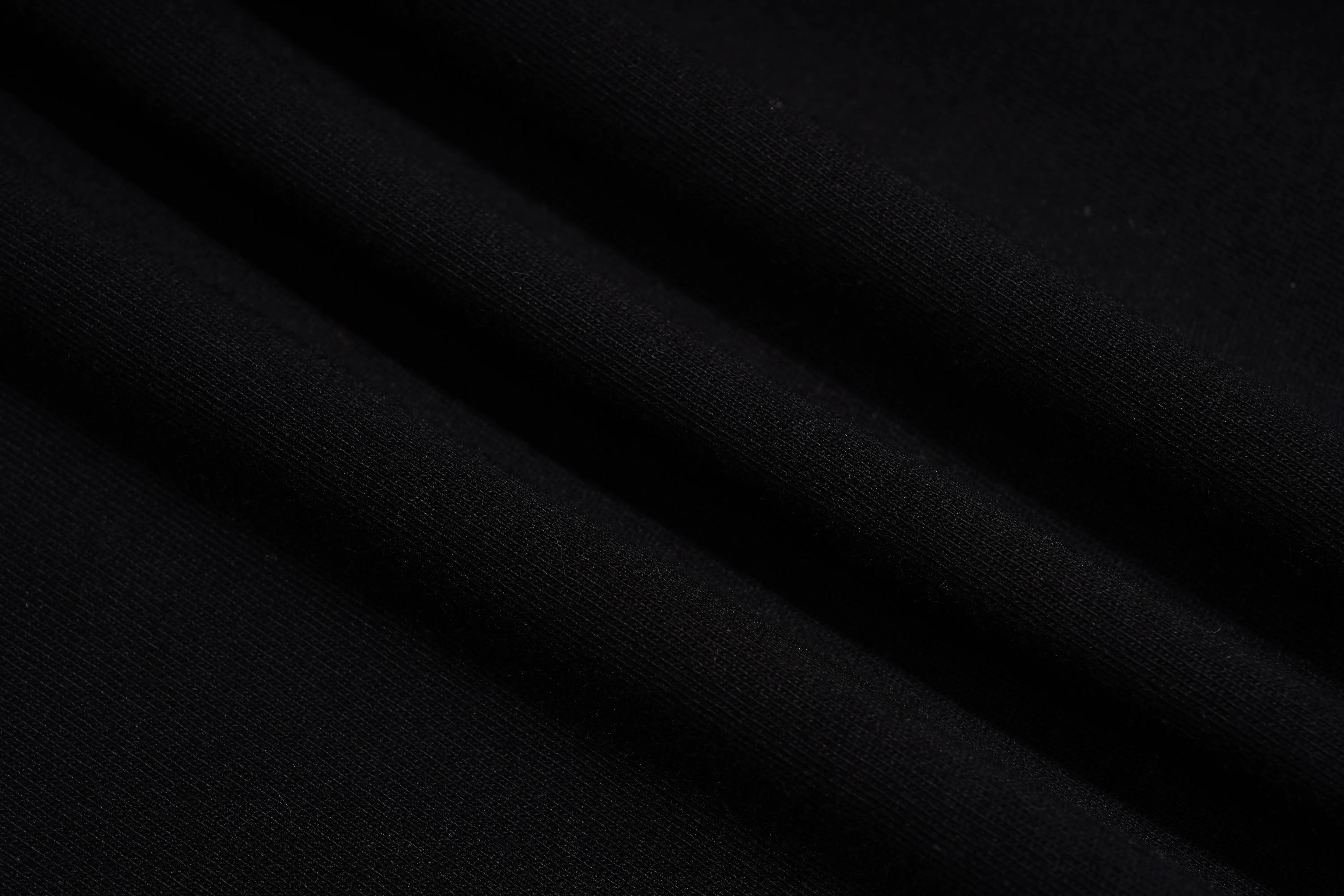Close-up of black fabric with visible texture, TCH Piggy Techno Rhinestone T-Shirt